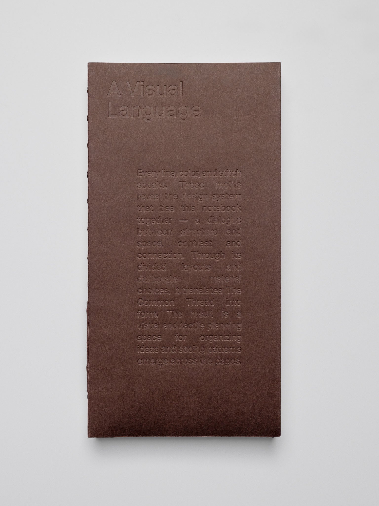 One Common Thread Notebook showing the dark brown cover.