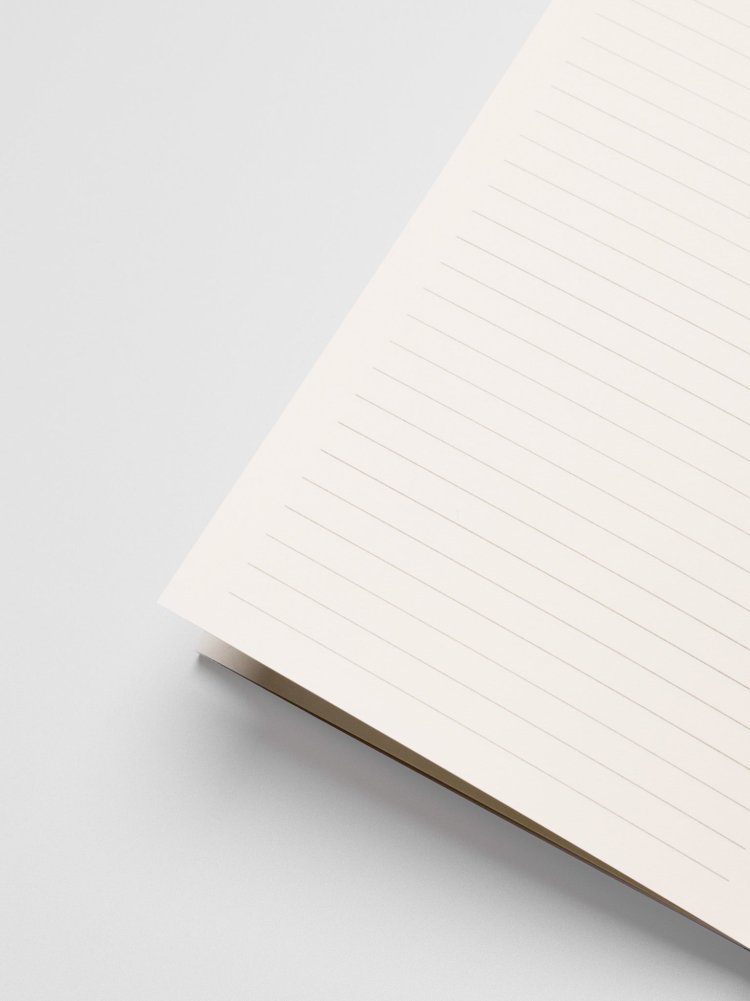 Close up of the Common Thread Notebook showing the white, lined interior pages.