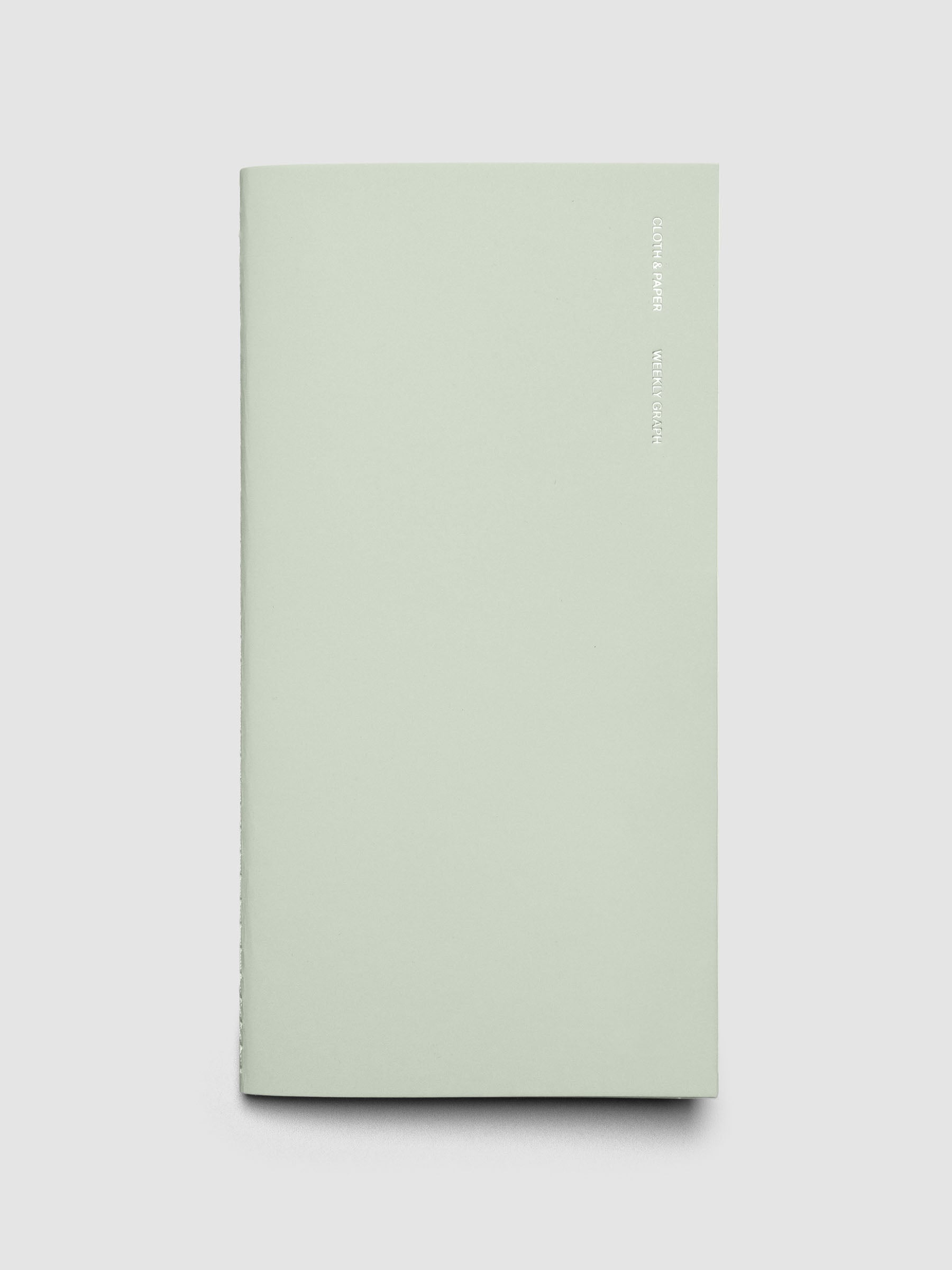 Travel Notebook in size A5 Slim in color Matcha with Weekly Graph pages shown closed.