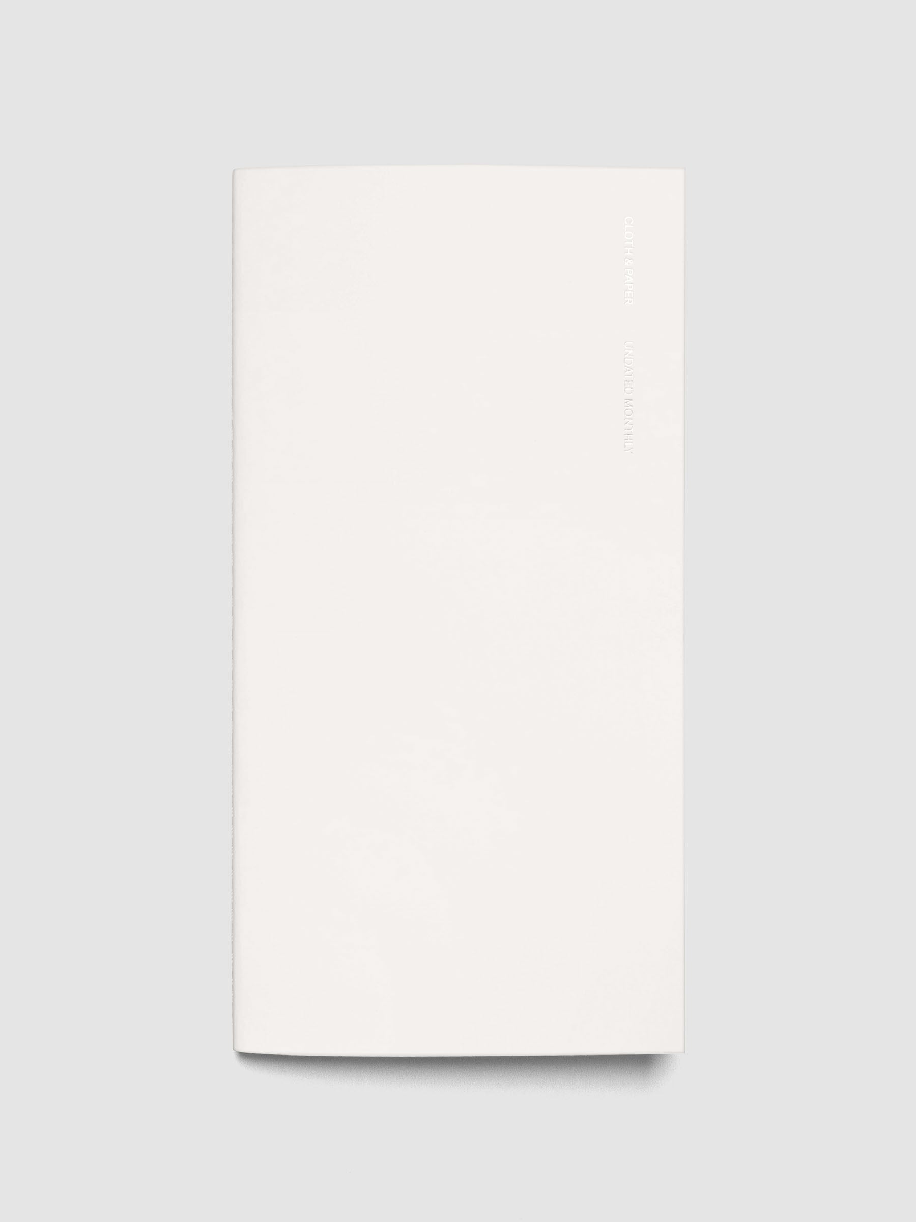 Exterior of a white pocket plus sized travel notebook.