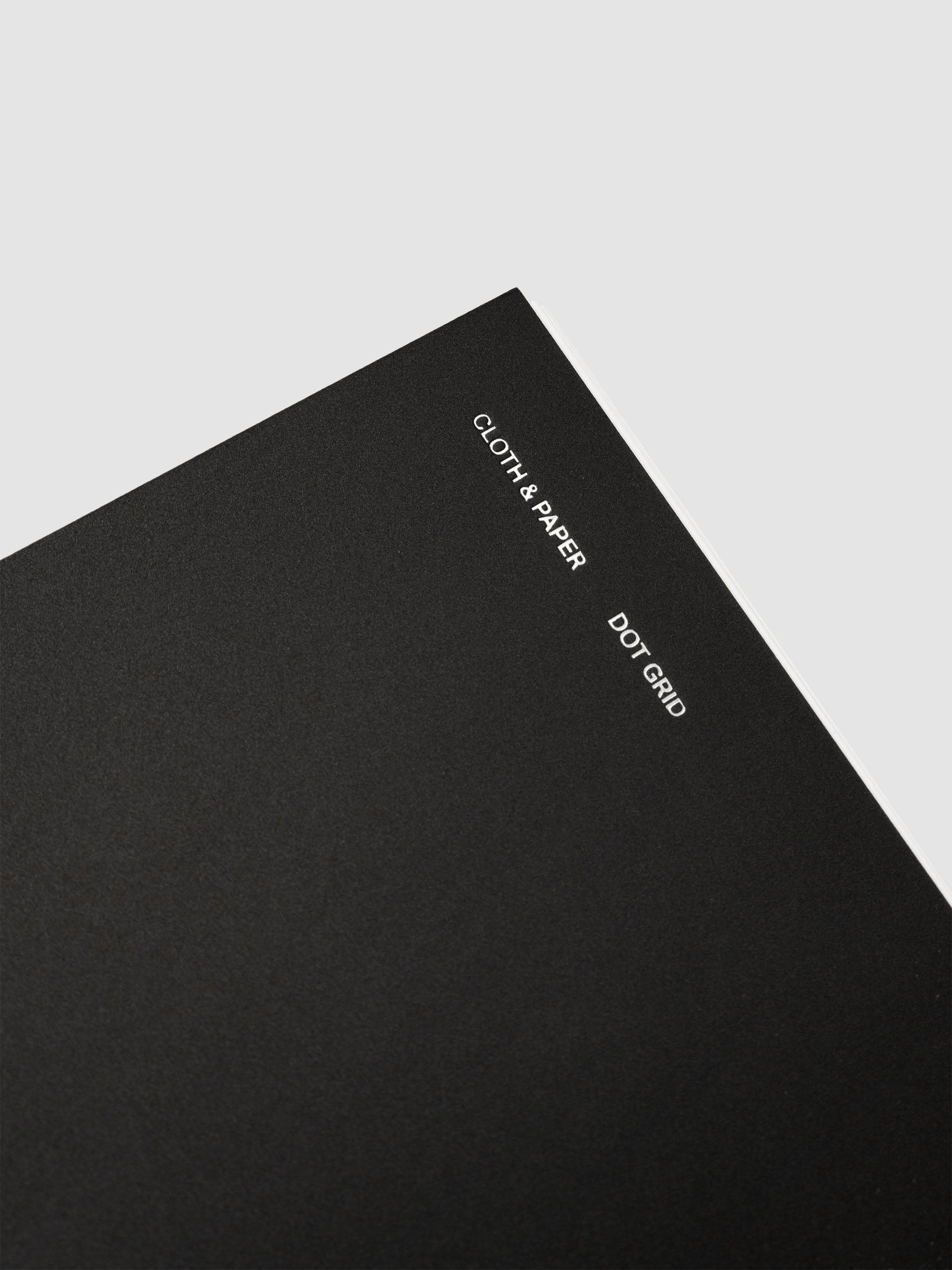 Spiral Notebook in size CP Petite and color Avant Garde with Dot Grid interior pages showing a close up of the foil details on the soft touch dashboard.