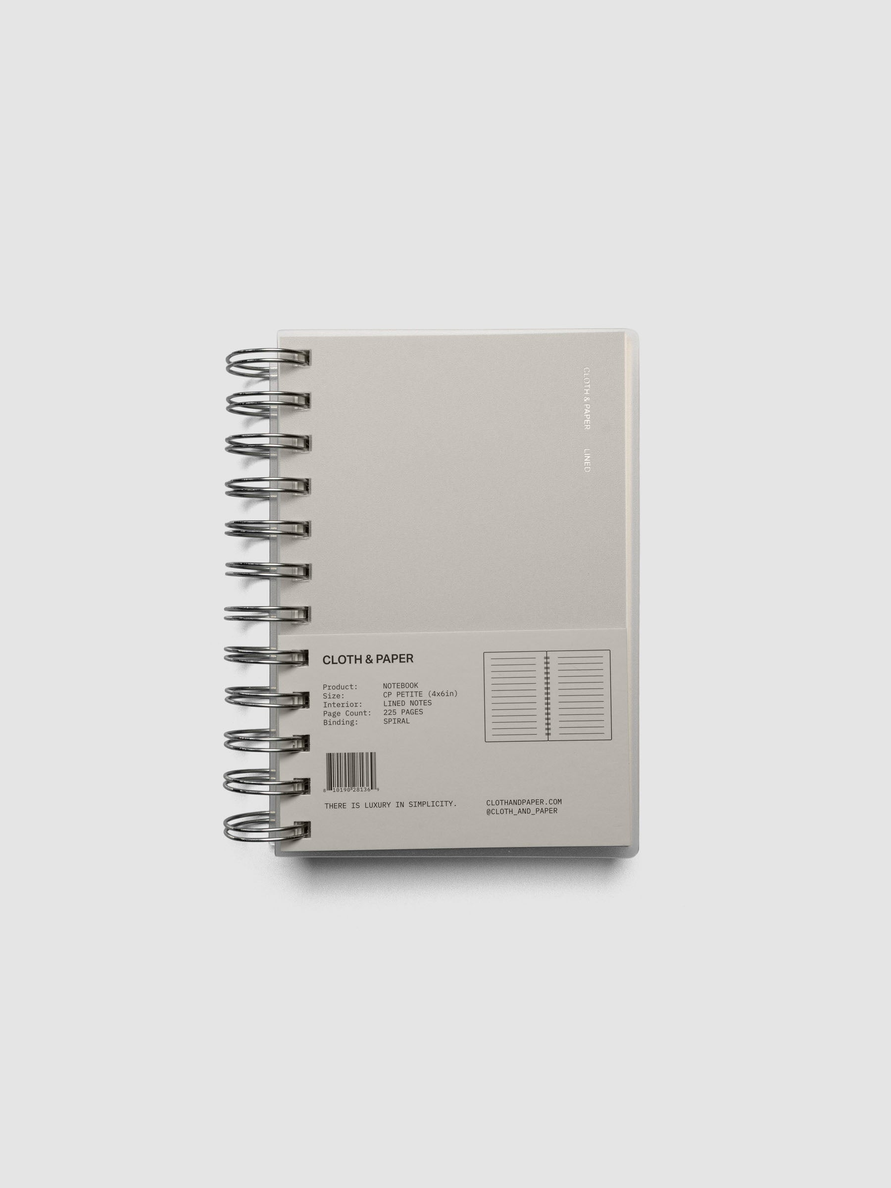 Spiral Notebook in size CP Petite and color Ash with Lined Note interior pages shown closed from the front with belly band.