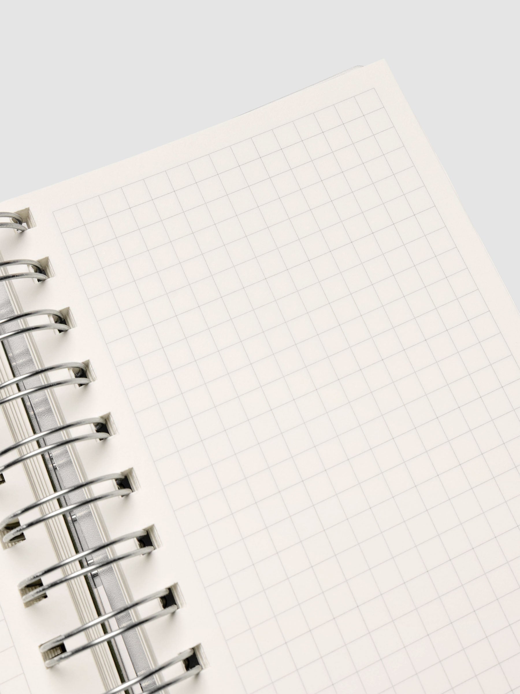 Spiral Notebook in size CP Petite with Graph Note interior showing close up of right page.