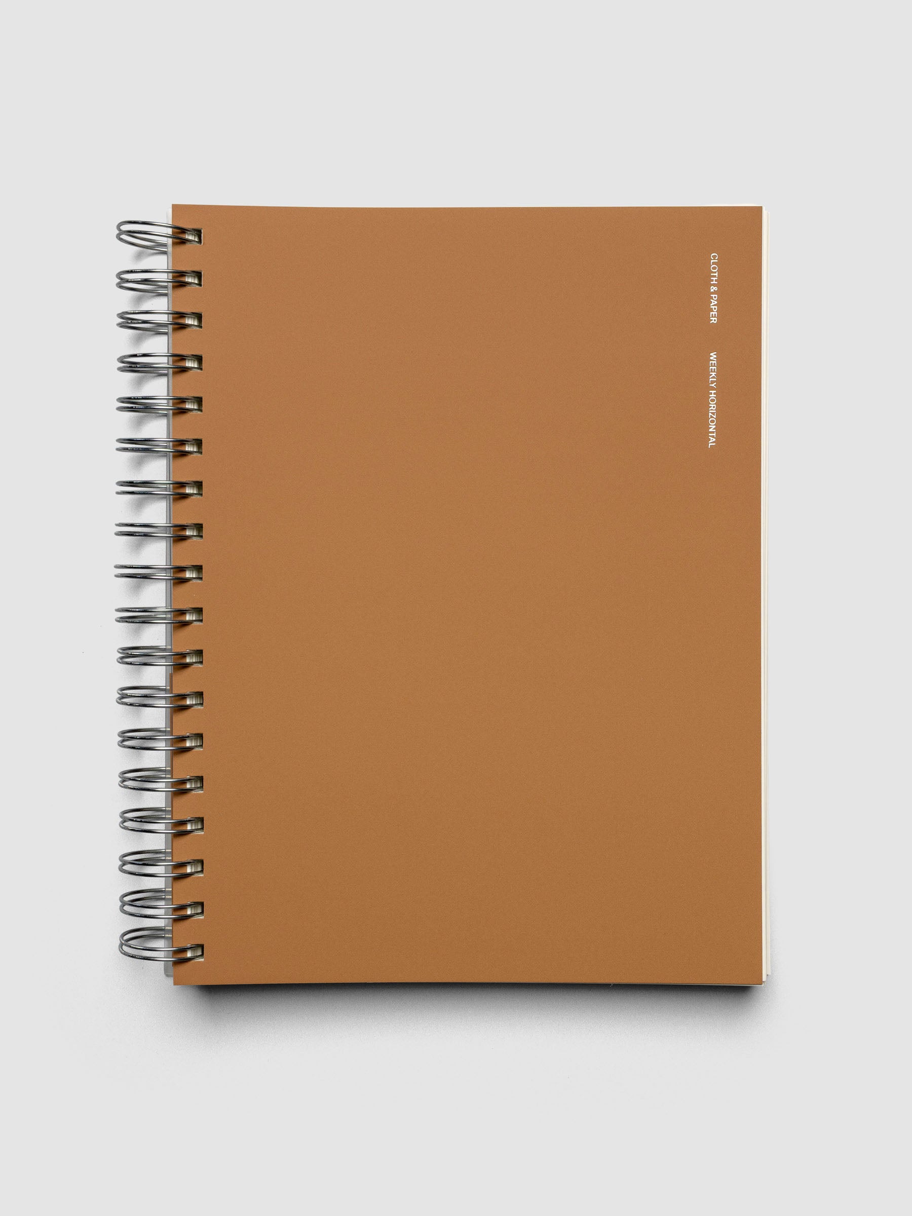 Spiral Notebook in size HP Classic and color Moscow (orange) with Weekly Horizontal interior layout shown closed.