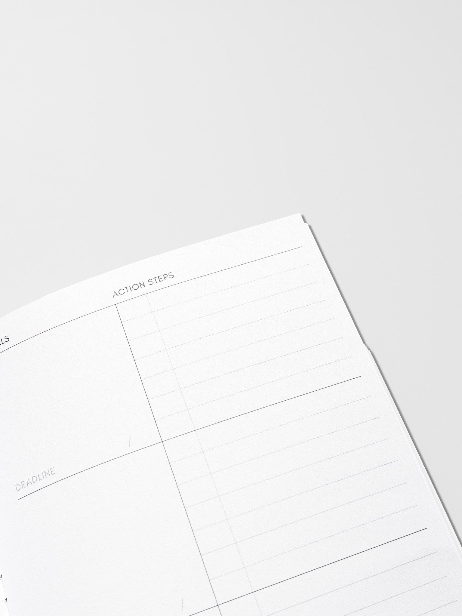 Interior of Goal Tracking Travel Notebook in size Pocket Plus displaying a two column layout in blank and task with fields for goals, deadlines, and action steps.