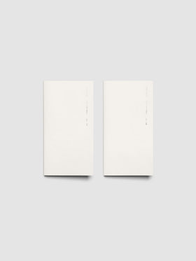 Both 2027 Dated Travel Notebooks in Pocket Plus size displayed side by side, showing the off-white covers with silver foil text for the Jan–Jun and Jul–Dec volumes