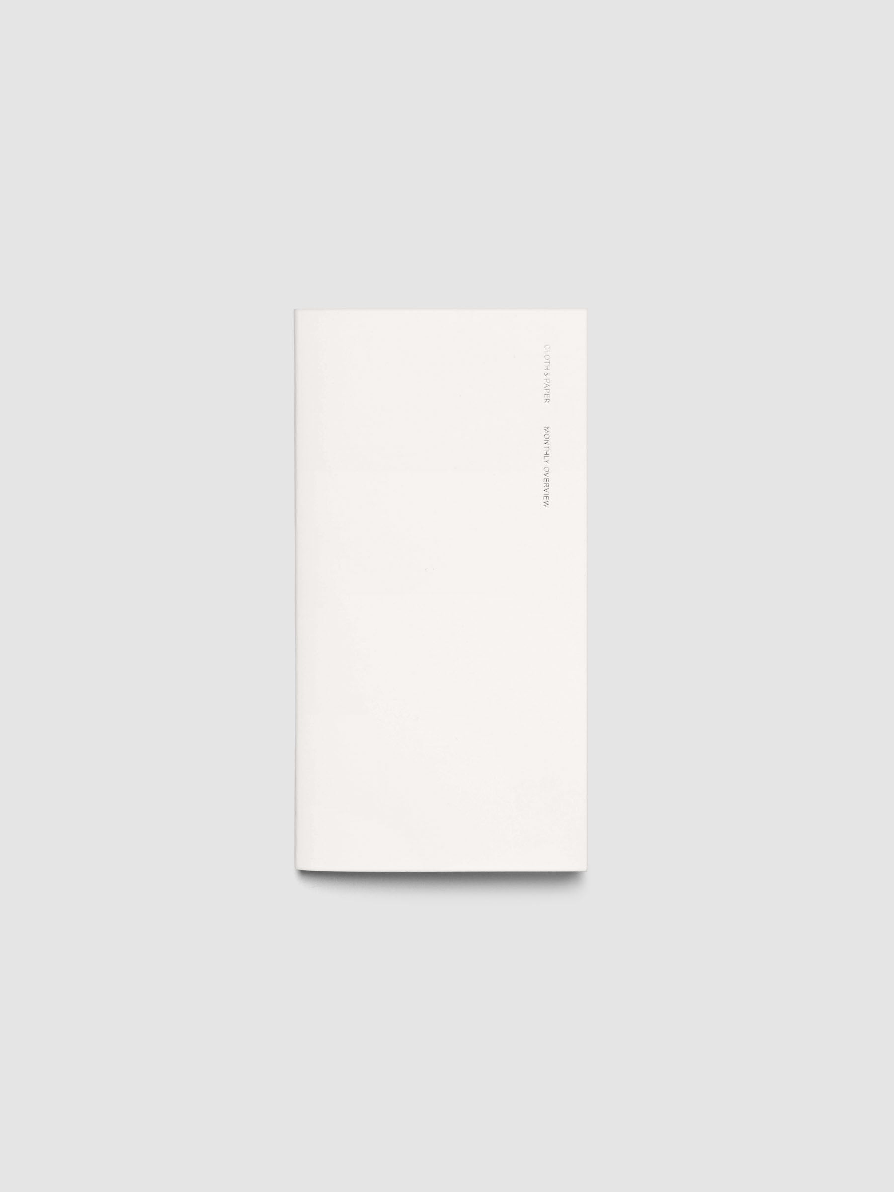 Exterior of a white pocket plus sized travel notebook.