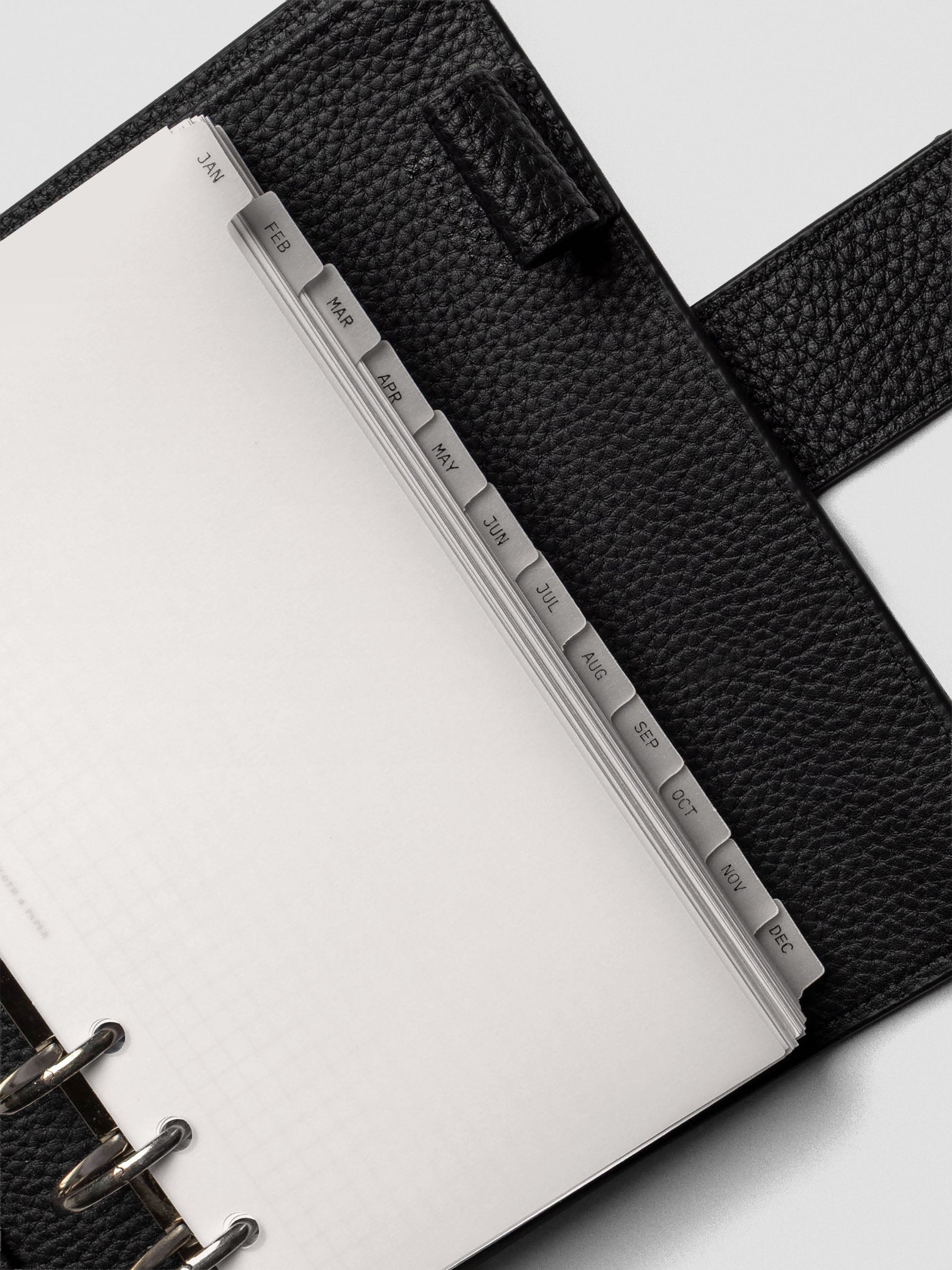 Close up of personal vellum dividers shown at an angle bound with rings.