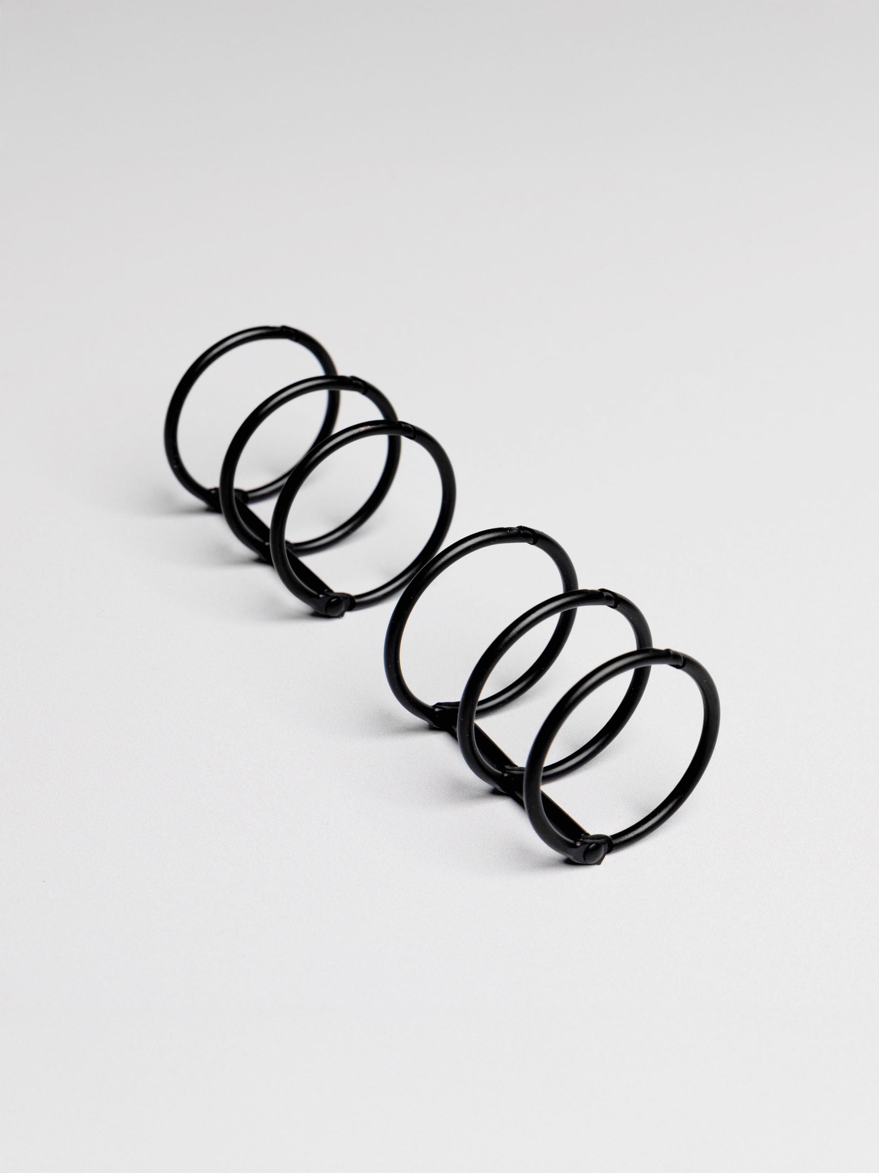 Planner rings displayed on a neutral background. Color shown is black.