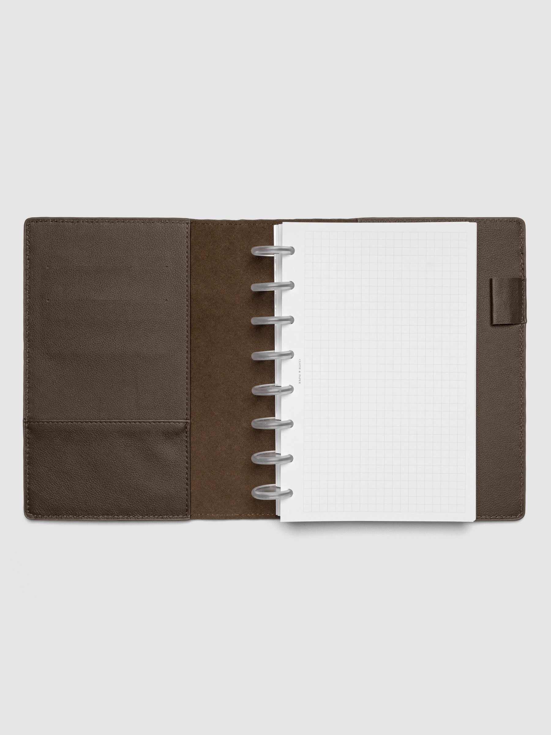Dark brown leather planner folio with an Half Letter discbound planner inside.