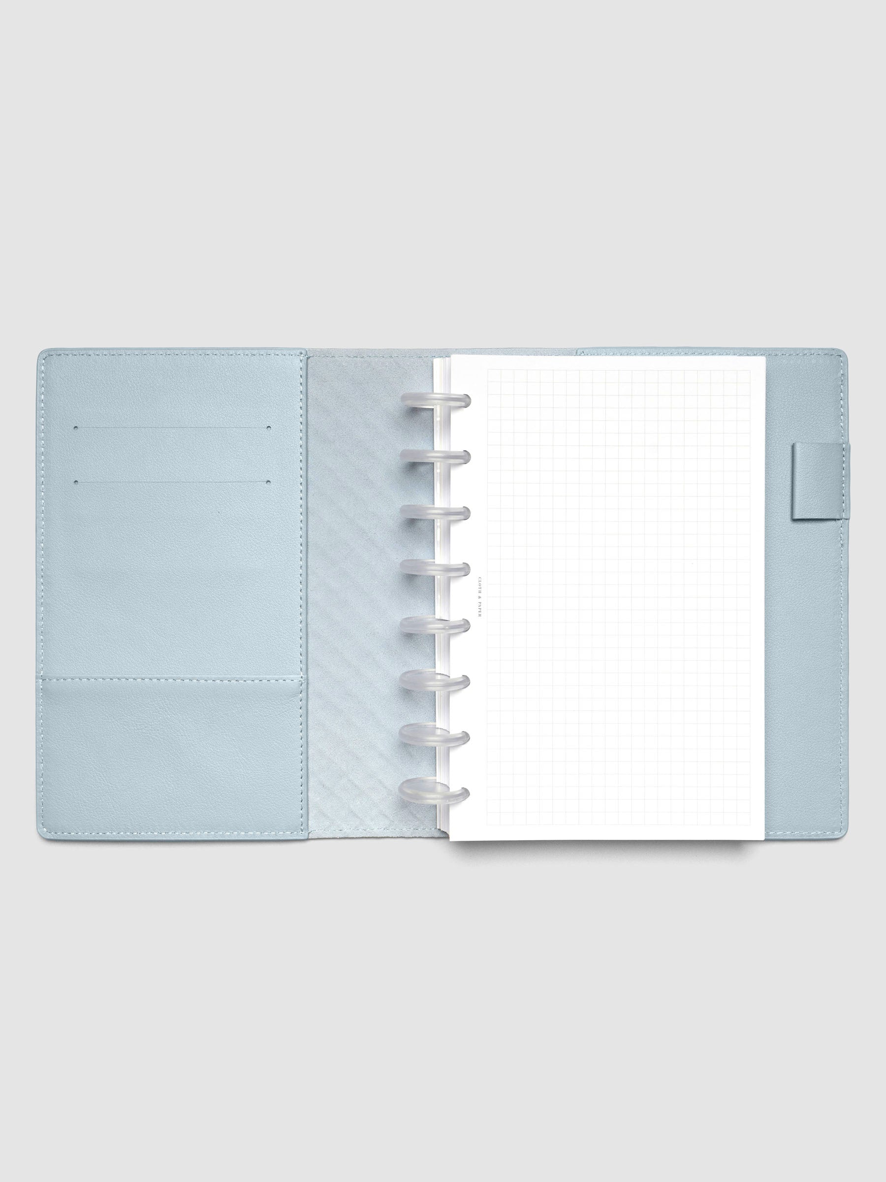Light blue leather planner folio with an Half Letter discbound planner inside.