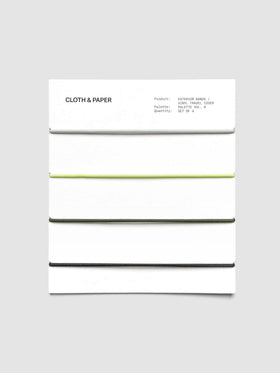 Set of four exterior elastic cover bands—grey, green, and black—on packaging card.