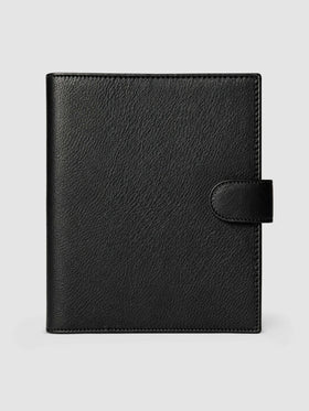 Black genuine leather A5 6-ring planner cover with gold magnetic snap closure, closed front view