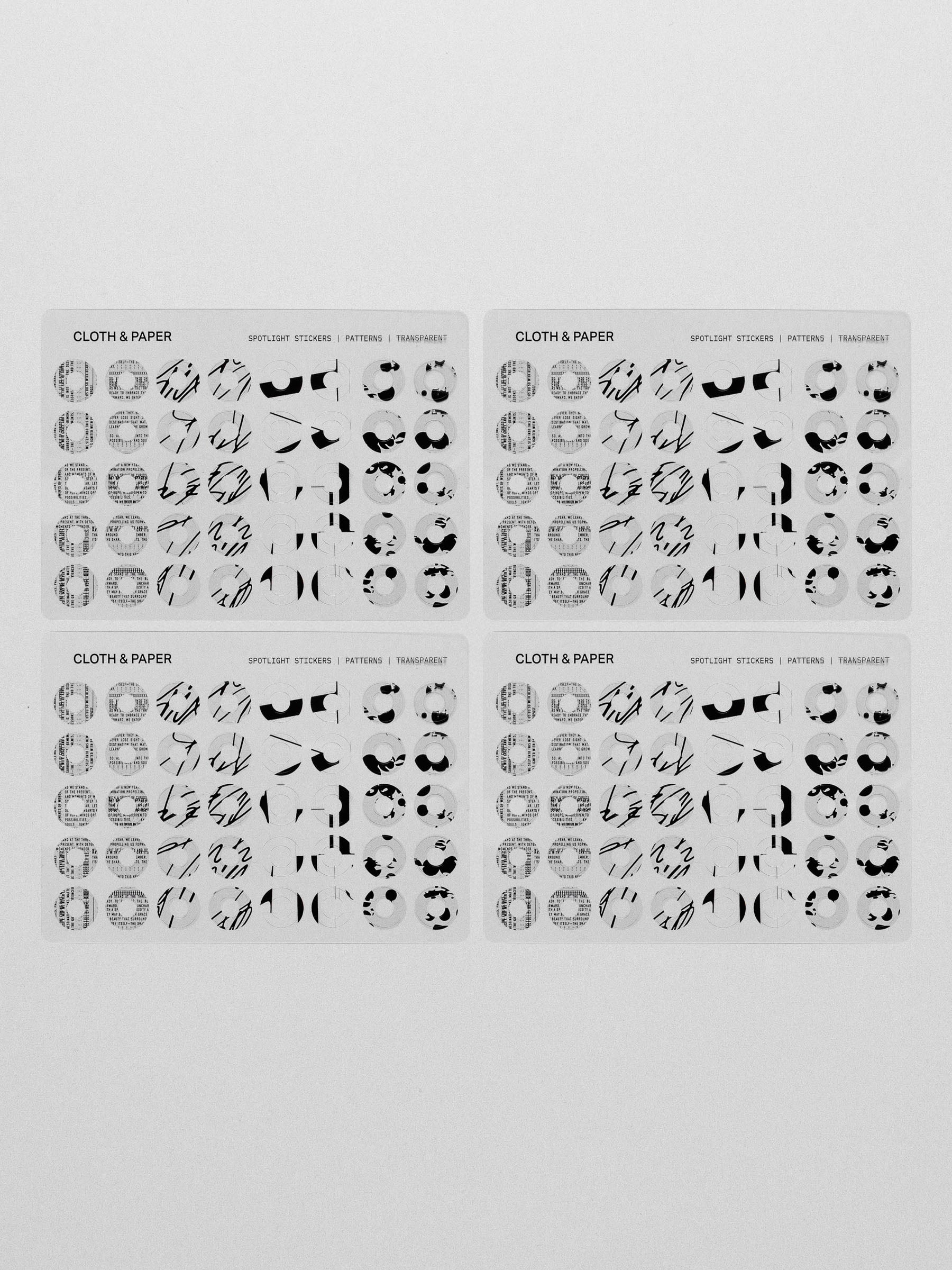 Four clear sheets of the spotlight sticker sets against a neutral background
