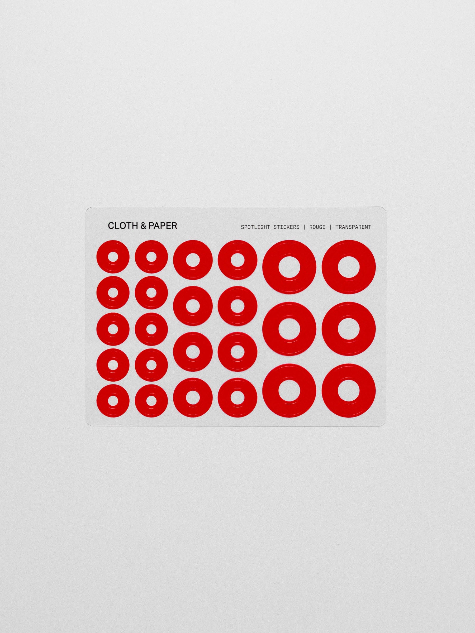 Red spotlight stickers on a clear sheet