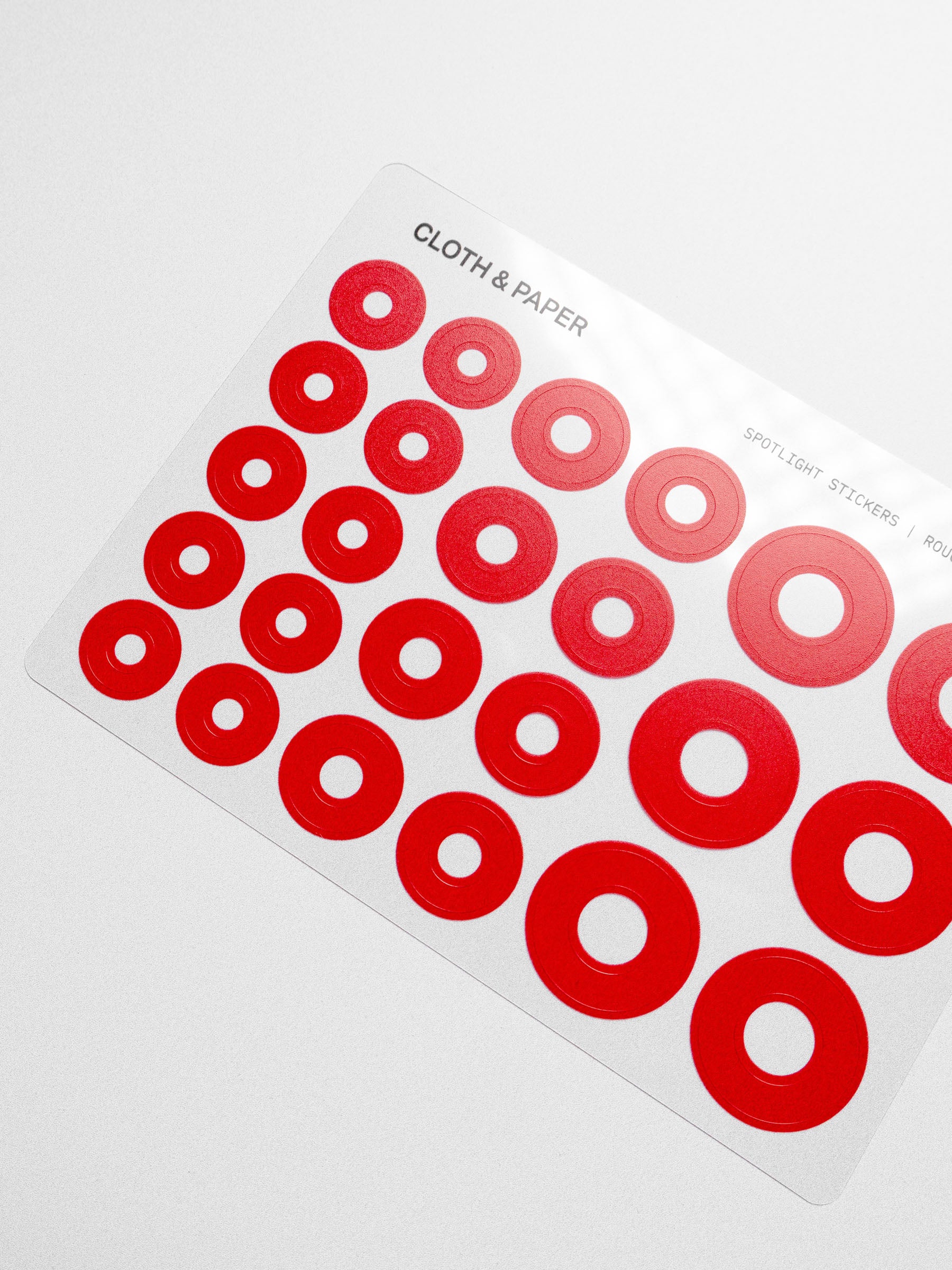 Red spotlight stickers on a clear sheet
