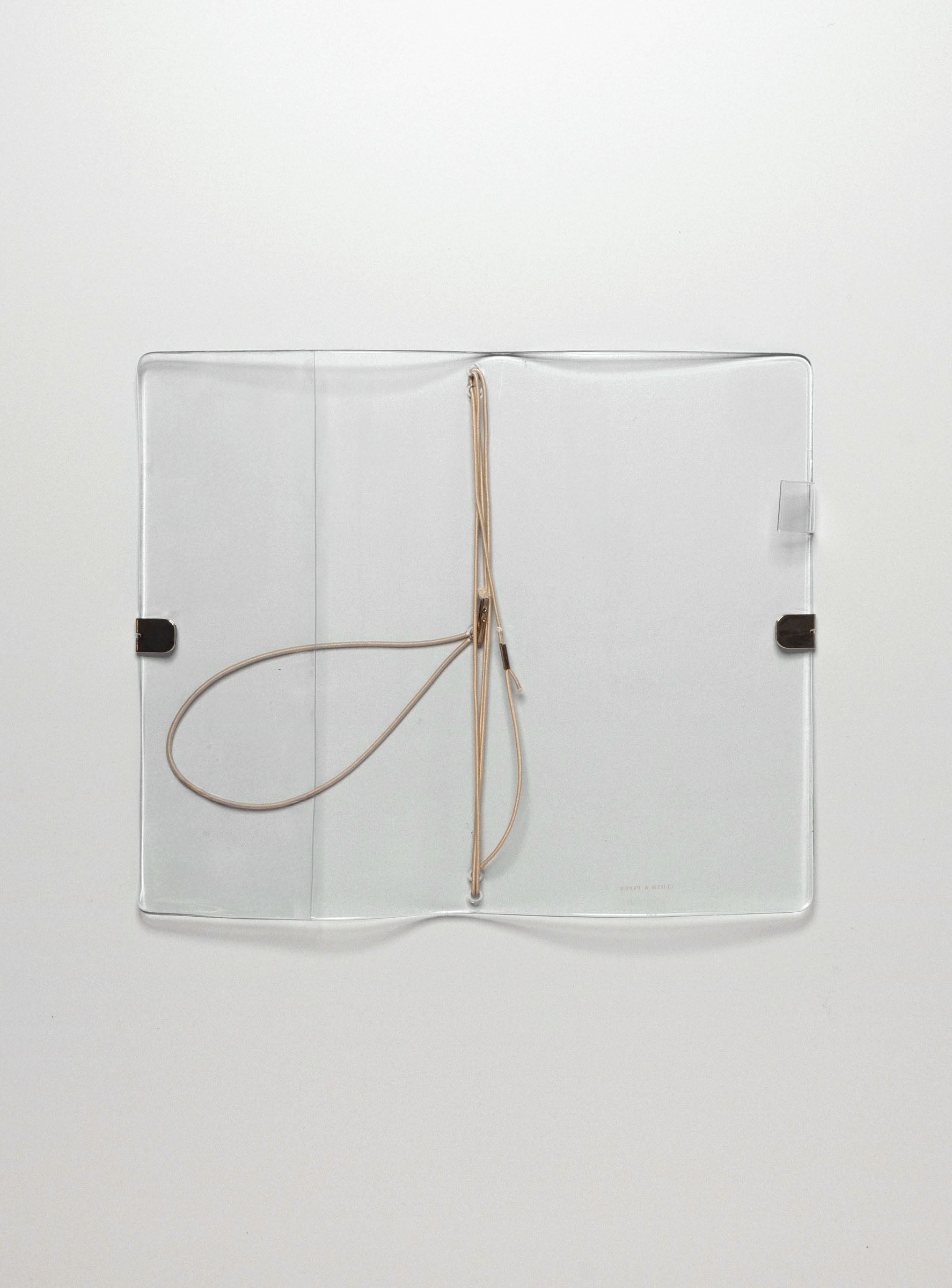 A clear vinyl planner on a neutral background