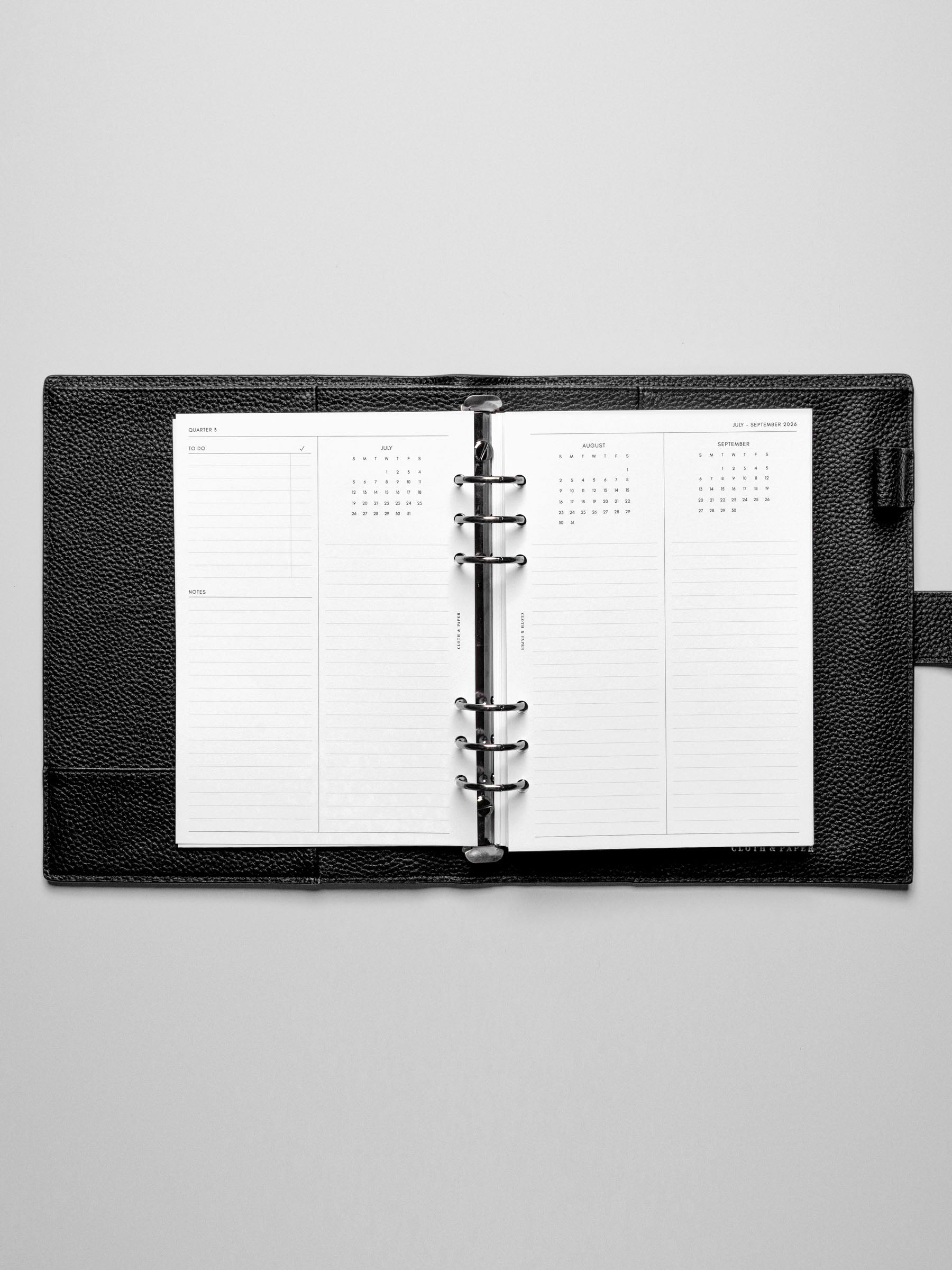 The 2026 Year Overview Planner Inserts in a black leather ring-bound planner.
