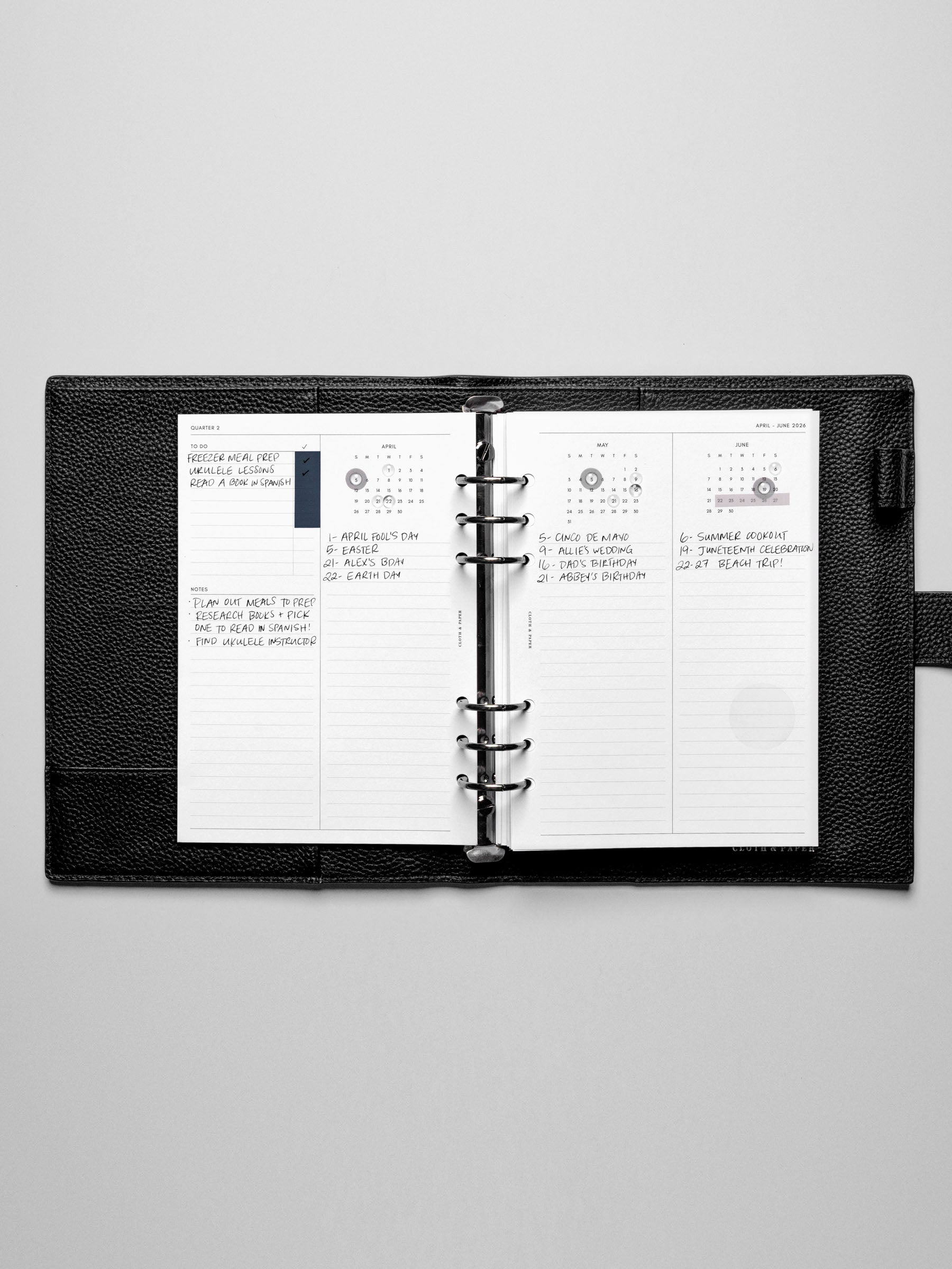 The 2026 Year Overview Planner Inserts in a black leather ring-bound planner.