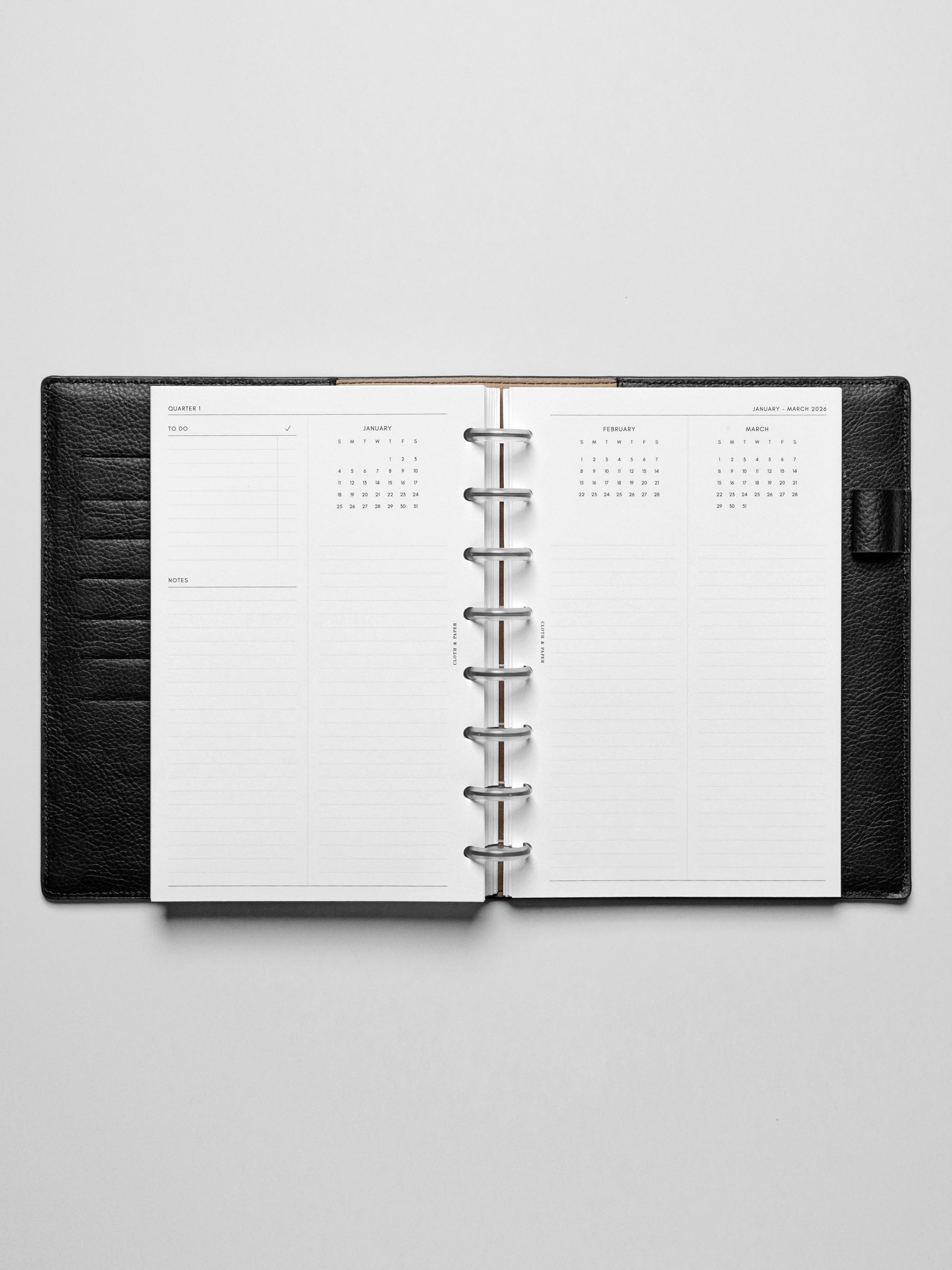 The 2026 Year Overview Planner Inserts in a black leather disc-bound planner.