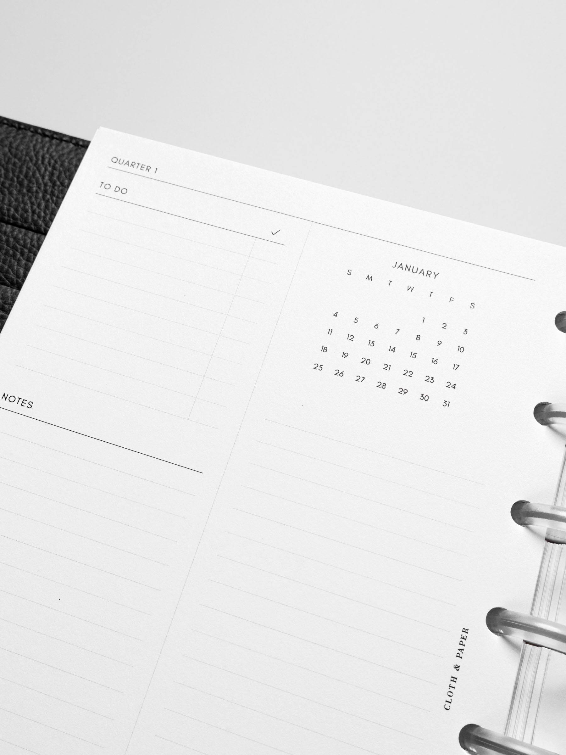 Close-up of the insert in a black leather disc-bound planner.
