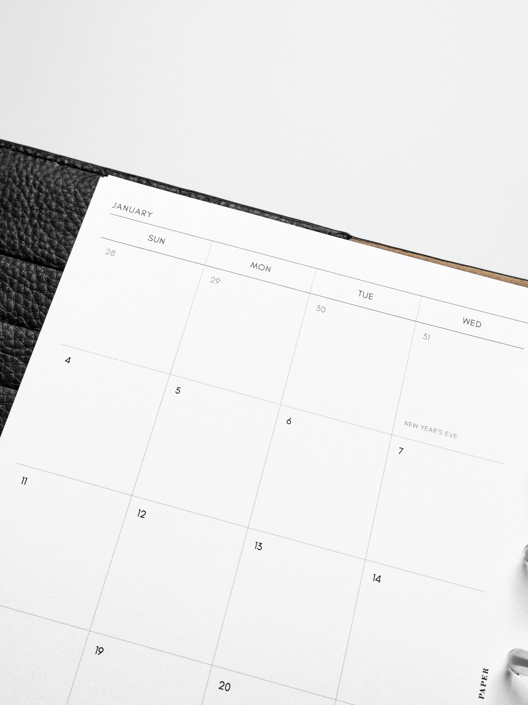 Images shows the Sunday Start 2026 Dated Monthly Planner Inserts in a black leather disc-bound planner.