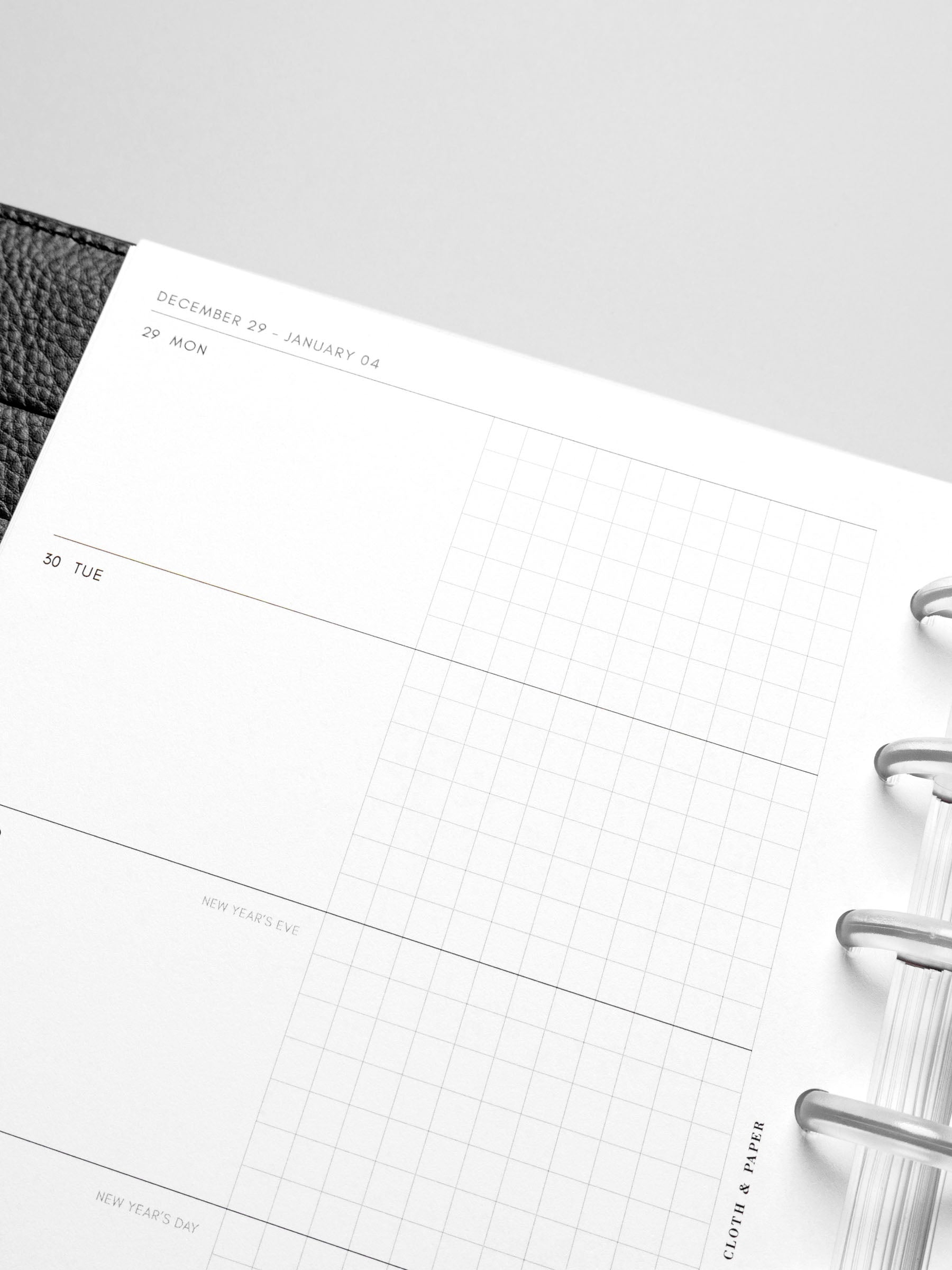 Closeup of inserts in use inside a leather planner.