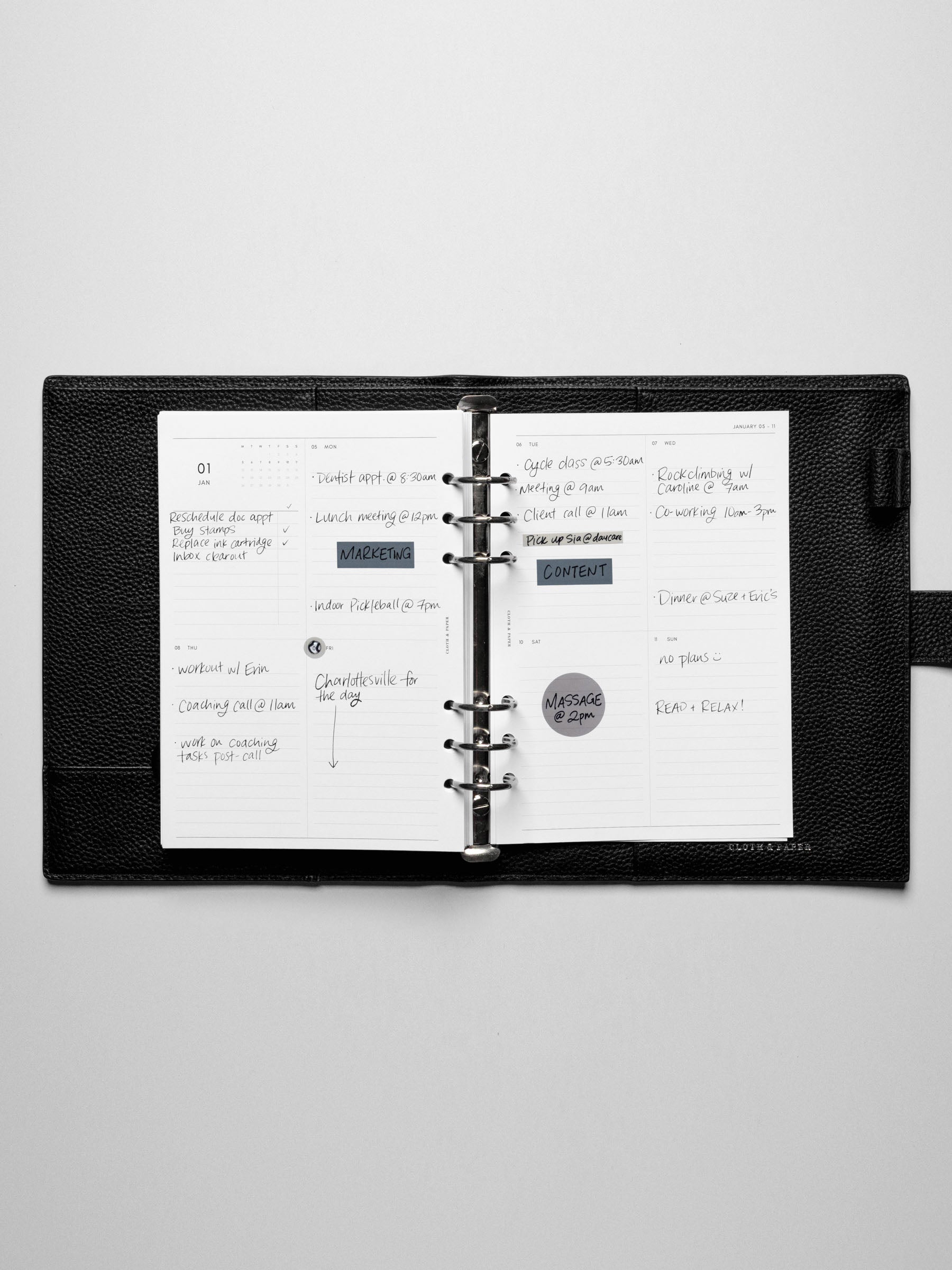 Image shows the Monday Start 2026 Dated Vertical Weekly Planner Inserts used in a black A5 leather binder. Stickers and sticky notes are used to highlight the notes.