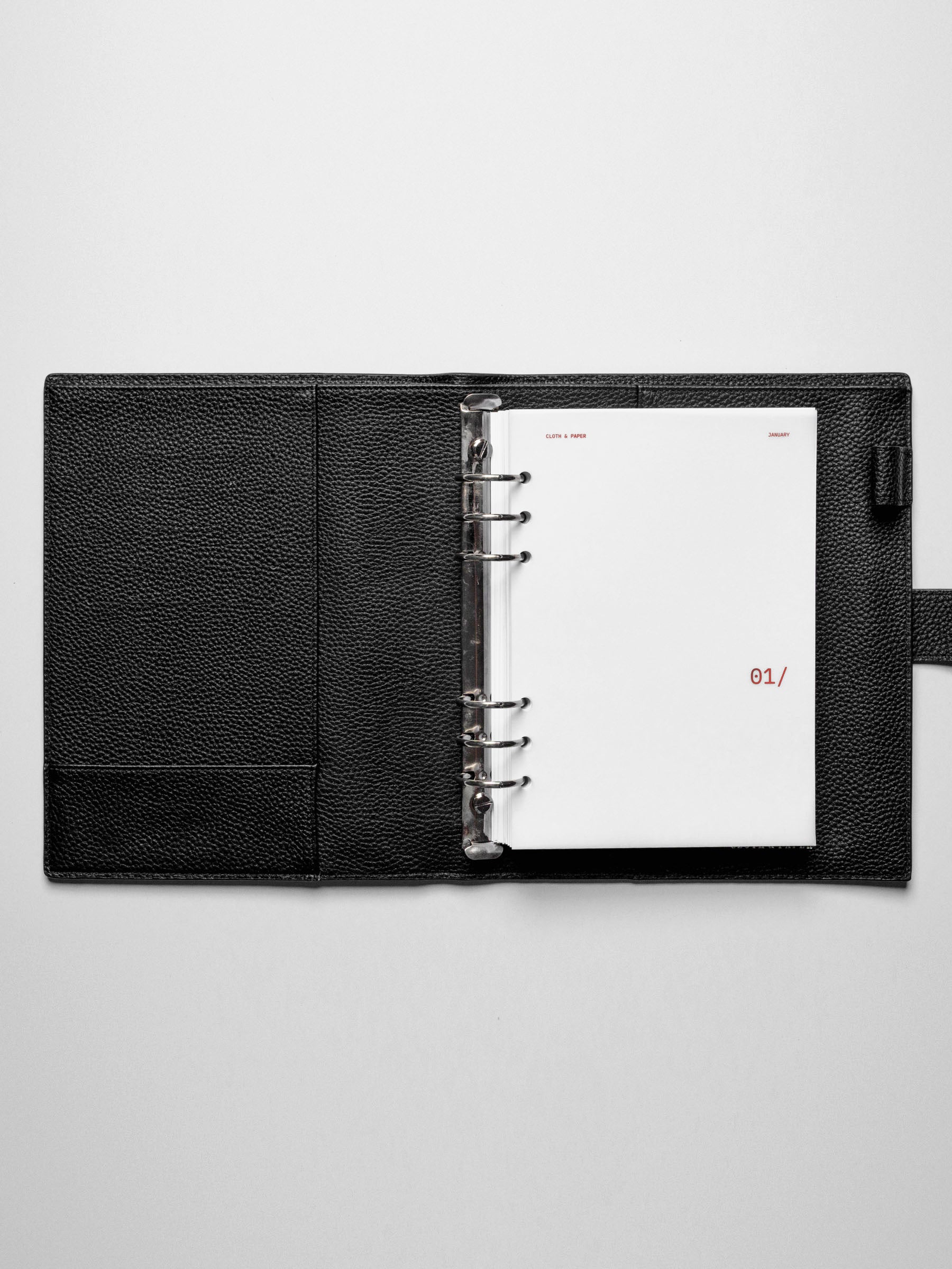 Image shows the January dashboard used in a black A5 ring-bound leather folio.