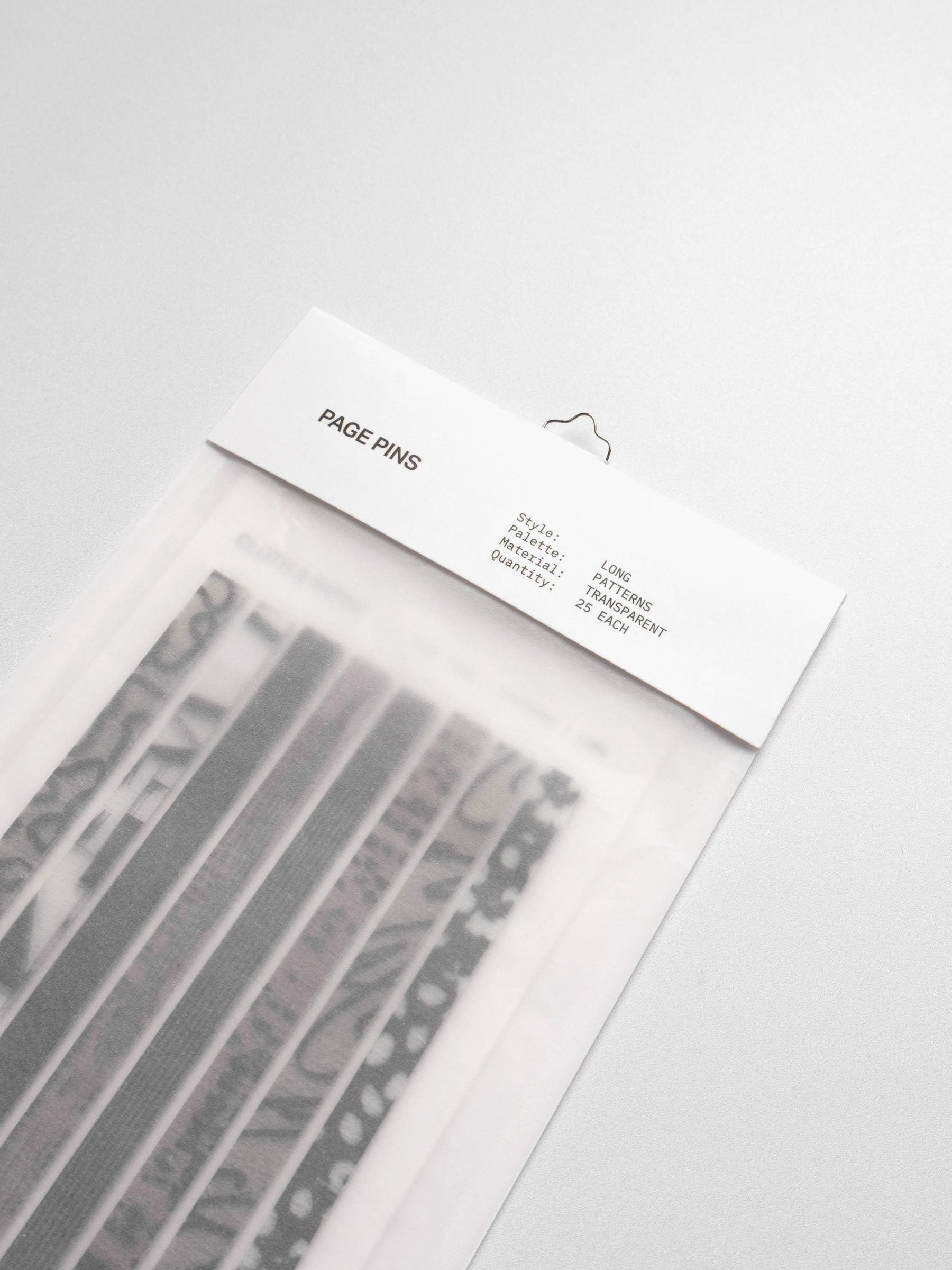 Long page pins displayed in their packaging on a neutral background.