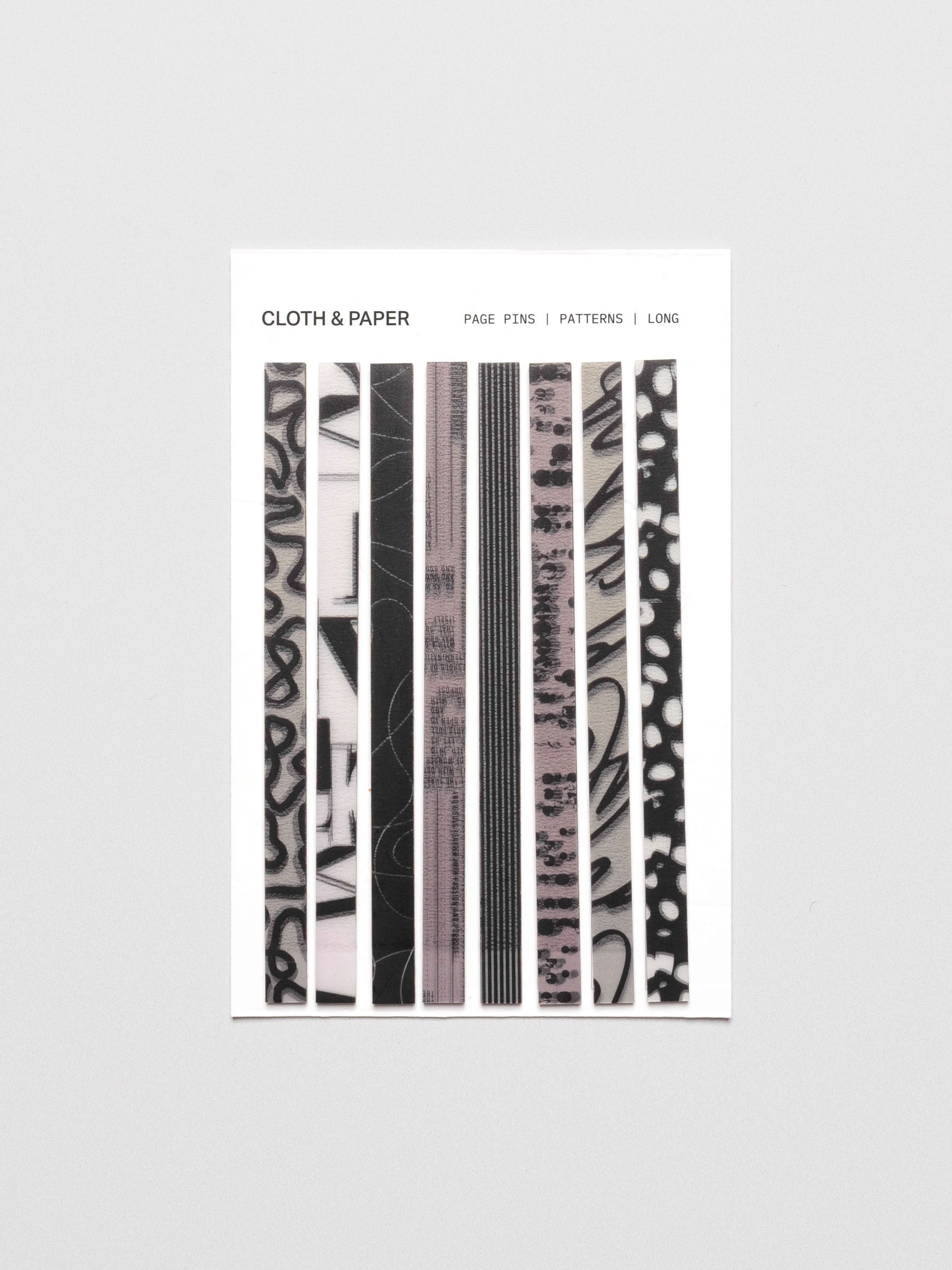 Long page pins displayed in their packaging on a neutral background.