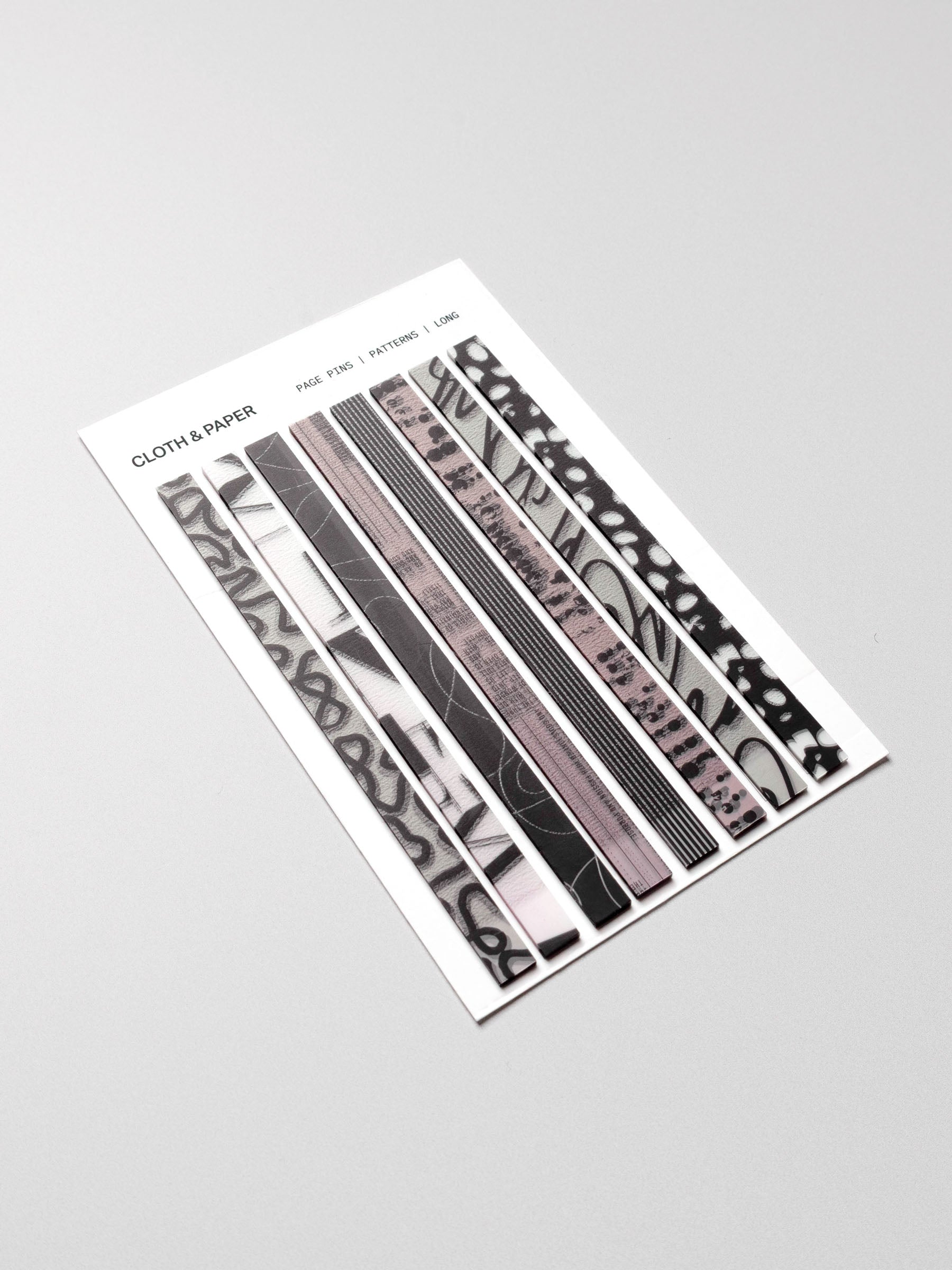 Long page pins displayed in their packaging on a neutral background.