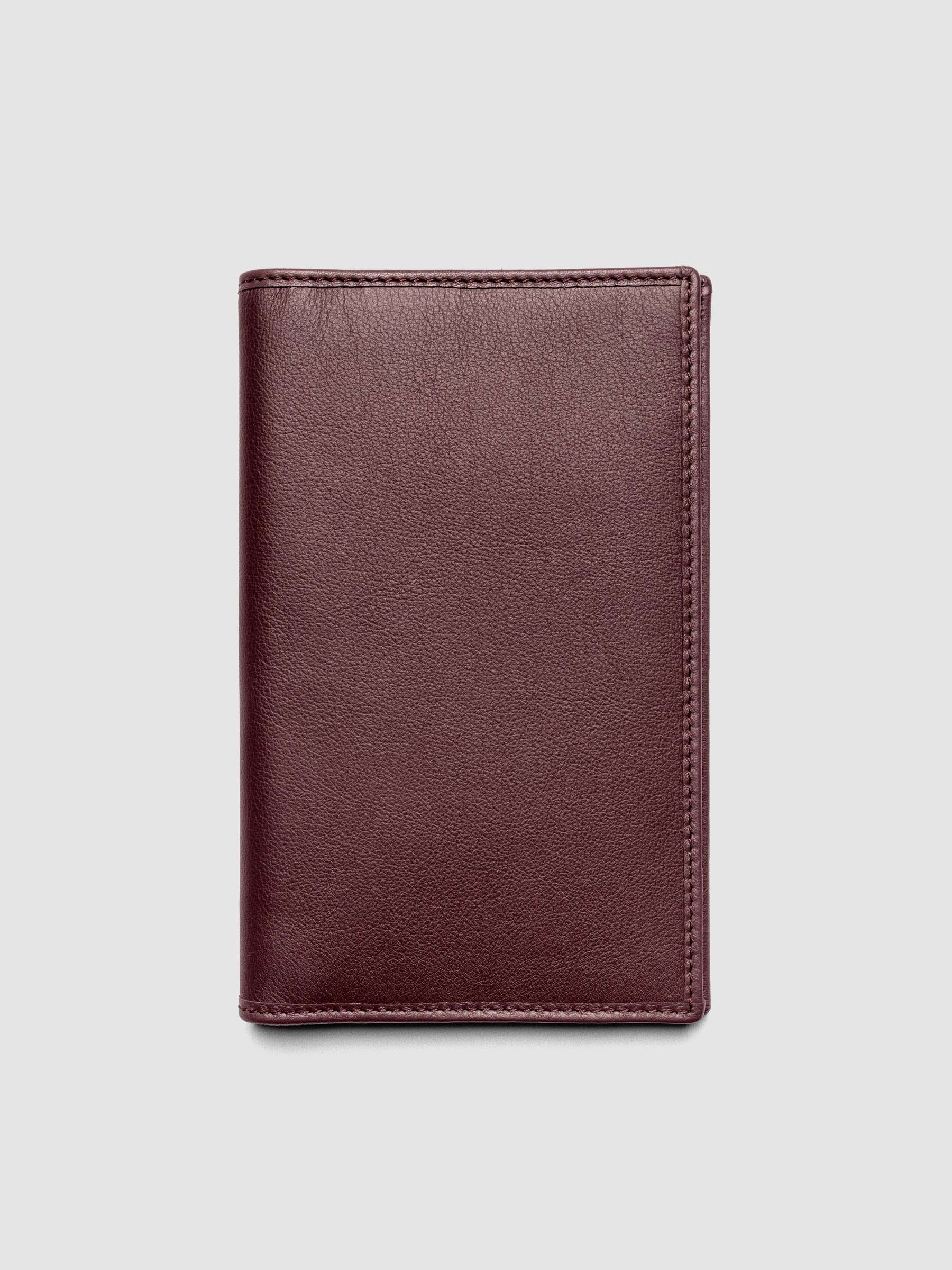 Nomada Wallet in Madrid closed, showing burgundy red Spanish leather exterior