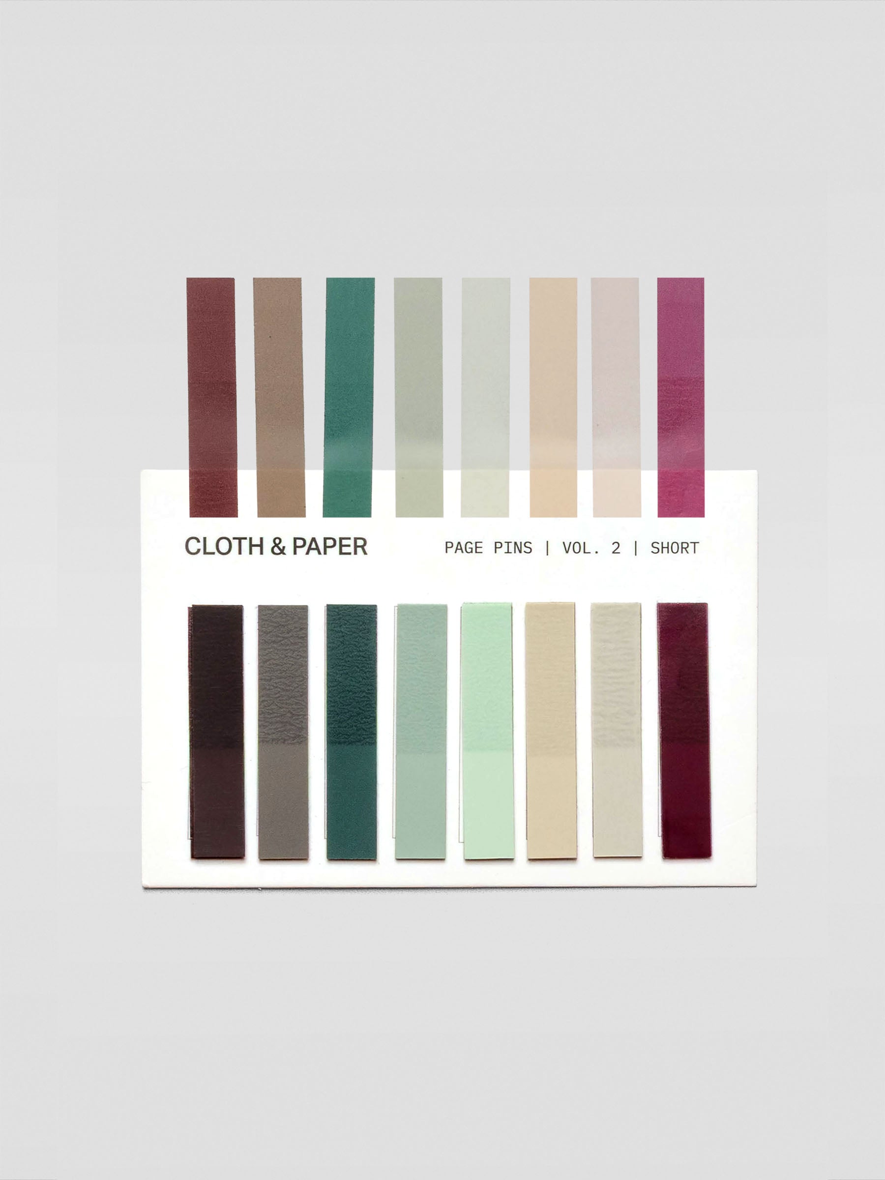Short page pins in volume 2, a set of 8 page pin solid colors including brown, grey, greens, beige, and red with one of each shown individually in addition to the stacks.