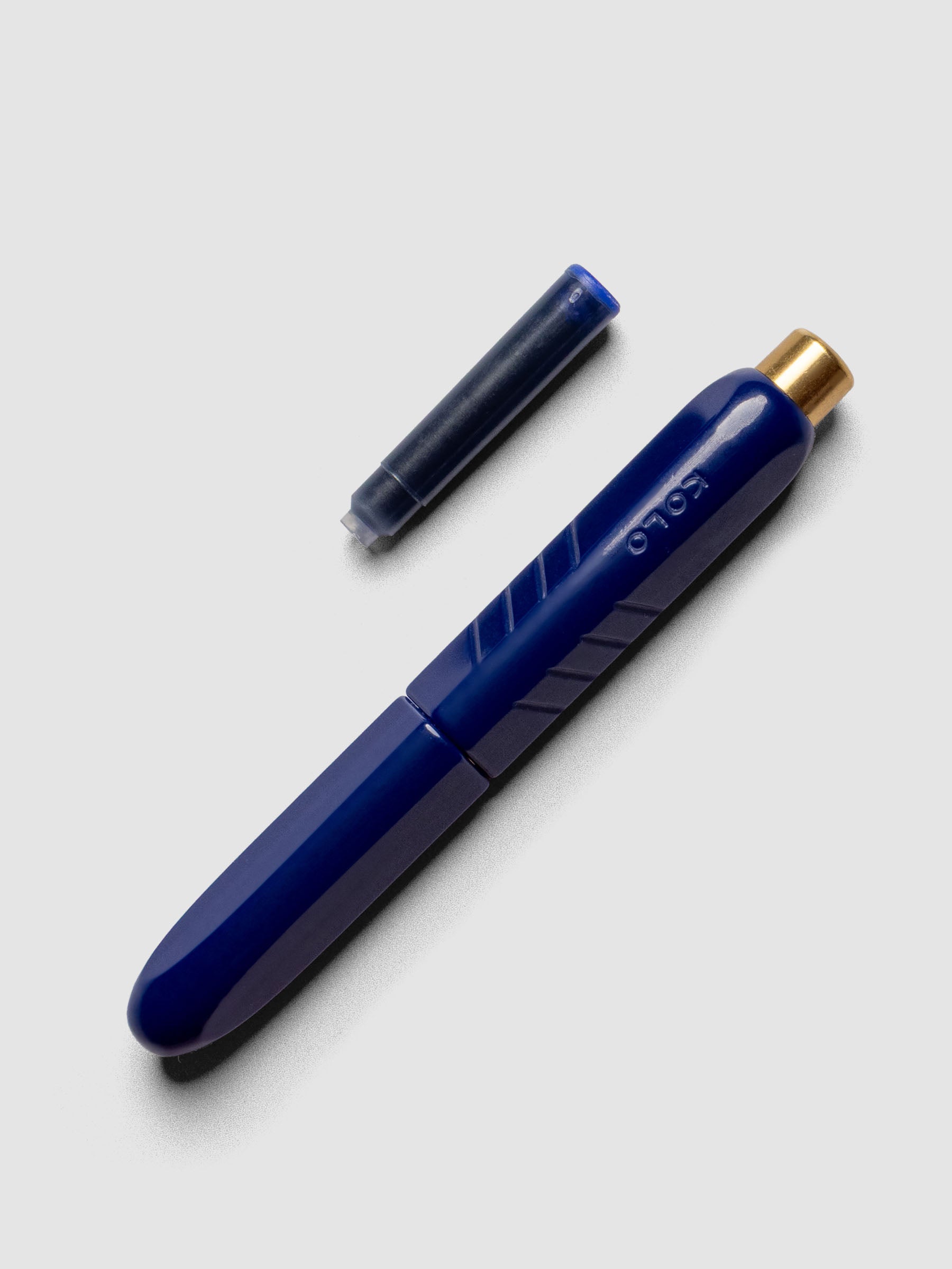 Kolo Tino Fountain Pen in the color Acrylic Albert Blue, shown cap on with ink cartridge resting beside pen.