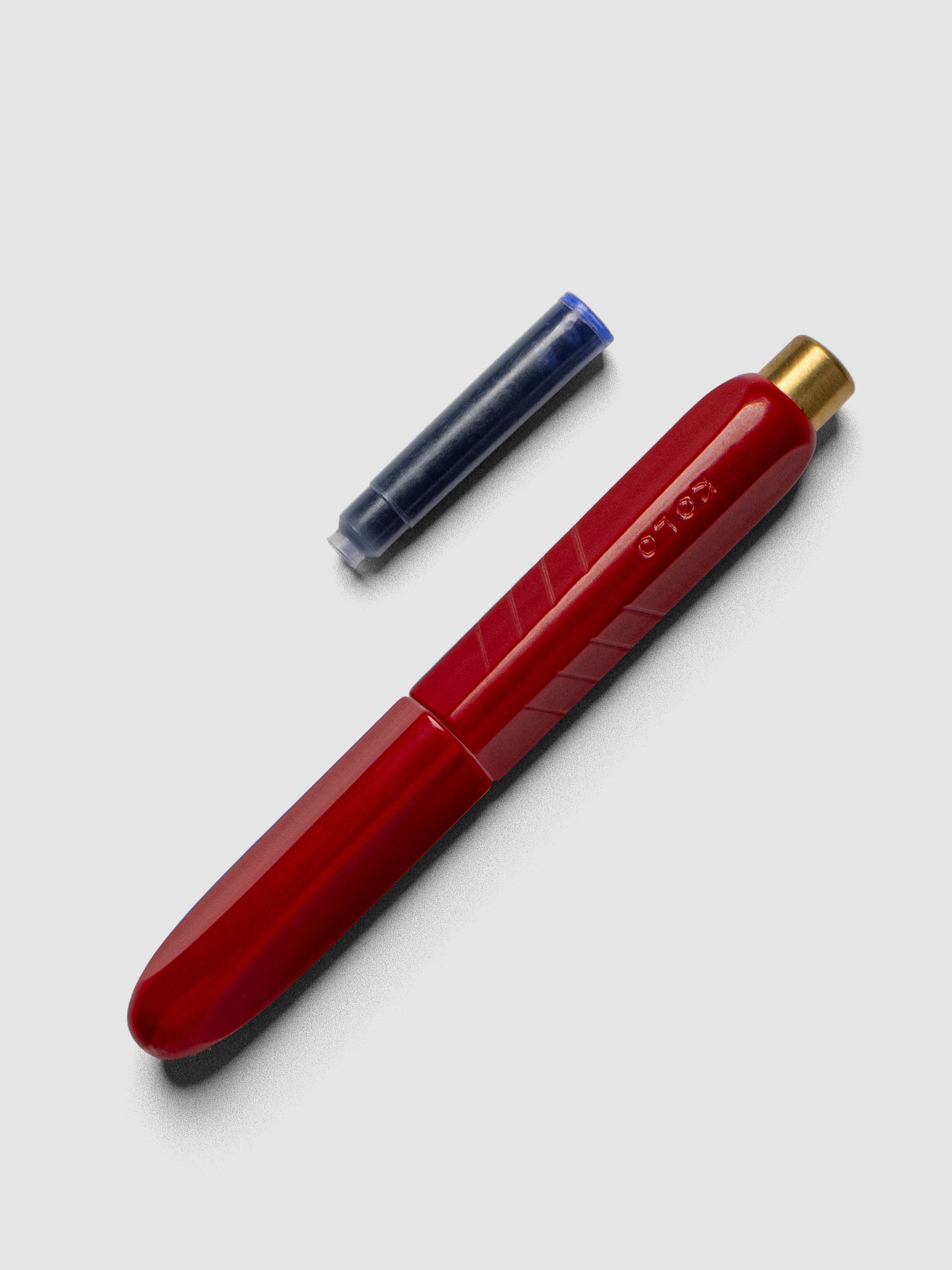 Kolo Tino Fountain Pen in the color Acrylic San Marzano, shown cap on with ink cartridge resting beside pen.