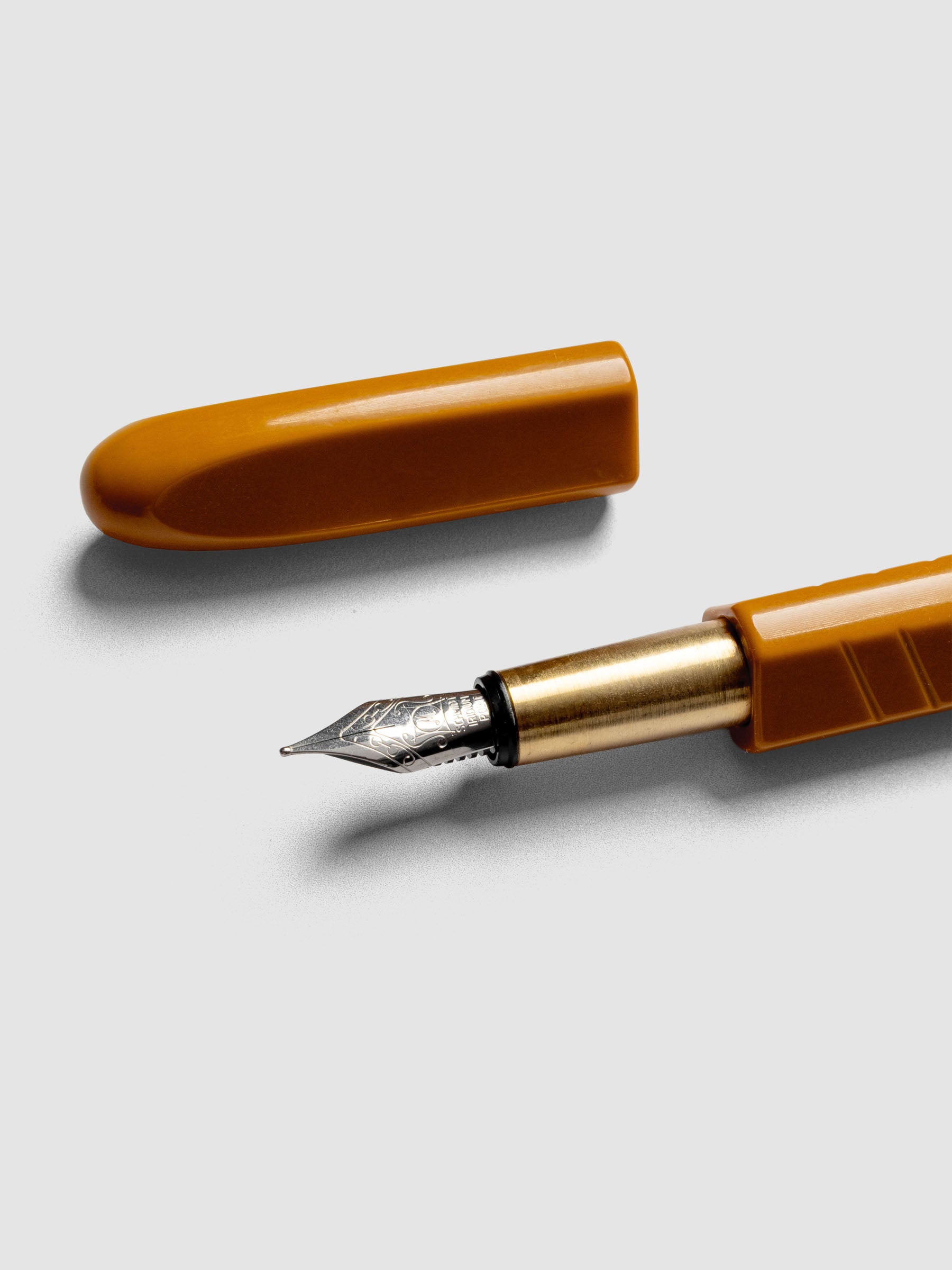 Kolo Tino Fountain Pen in the color Acrylic Sunny, a golden yellow with brass accents and a silver medium nib shown with cap off.