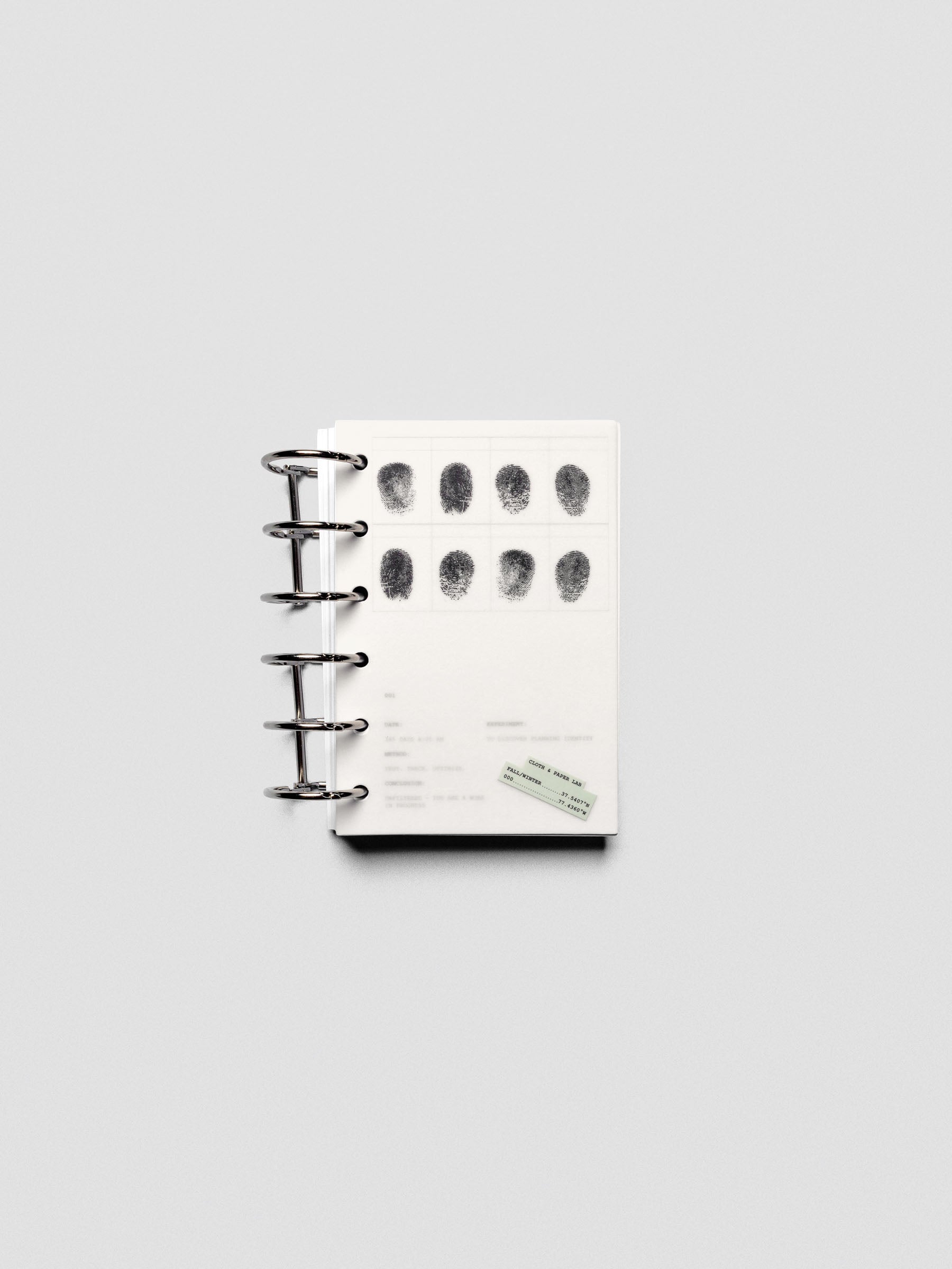 Two layered Pocket sized planner dashboards, one semi-transparent, one matte, featuring a fingerprint design shown in a ring bound planner.