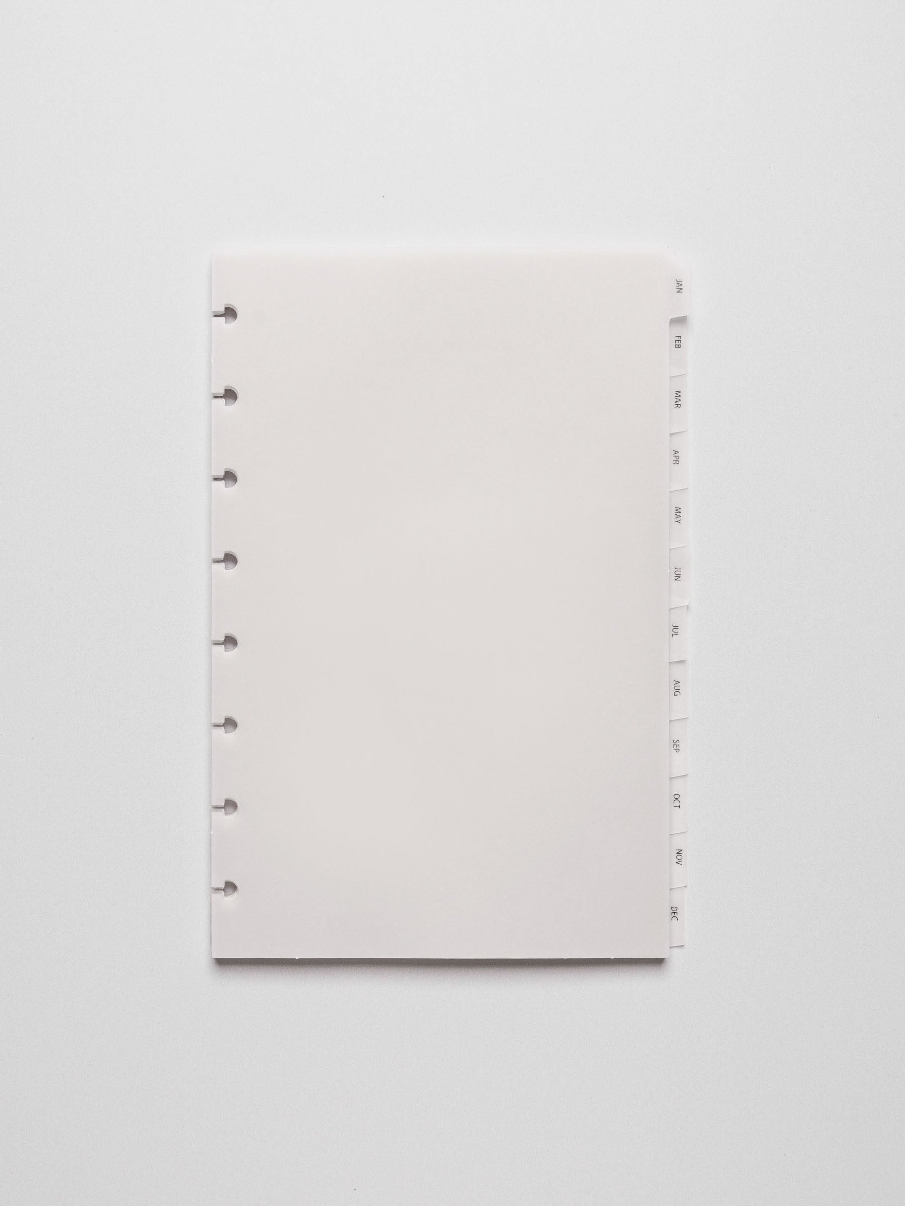 Close up of Half Letter vellum dividers shown at an angle bound with discs in a folio.