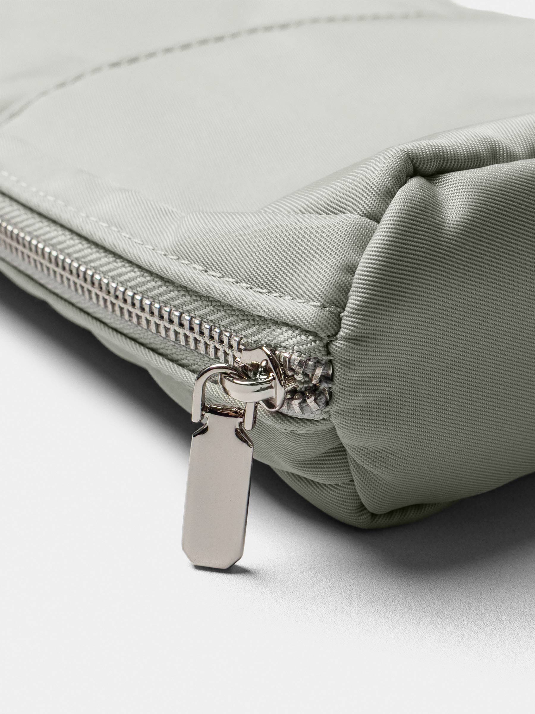 Close-up of the silver zipper pull and stitching detail on the Matcha Fountain Pen Travel Case.