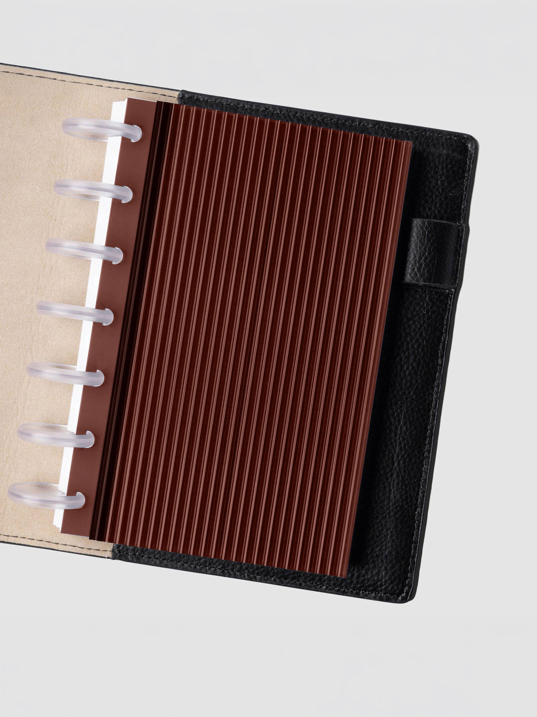 Bordeaux fluted planner dashboard in HP Mini size shown in a black leather discbound cover with clear discs.