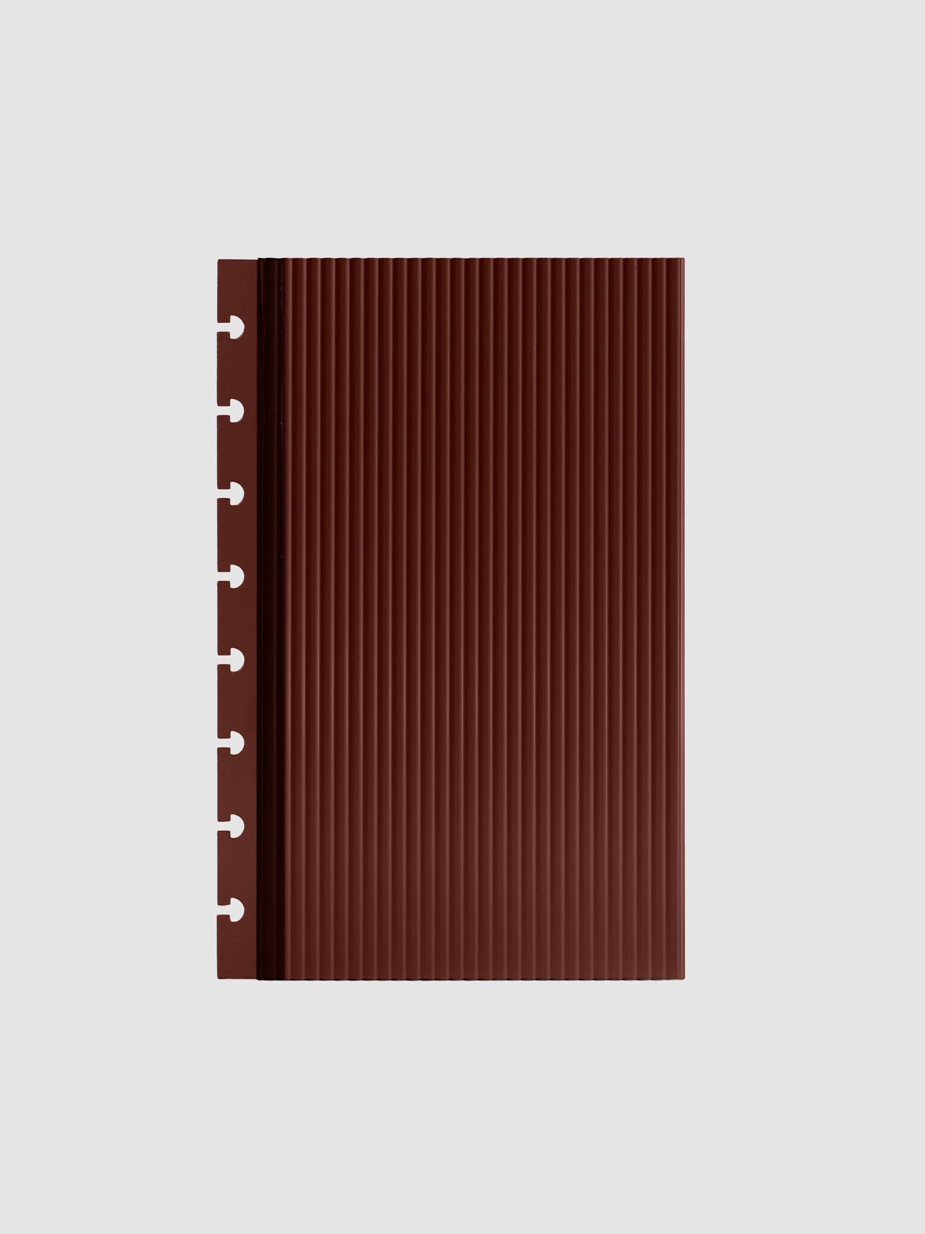 Bordeaux fluted planner dashboard in Half Letter size, eight disc punch, shown flat on a grey background.