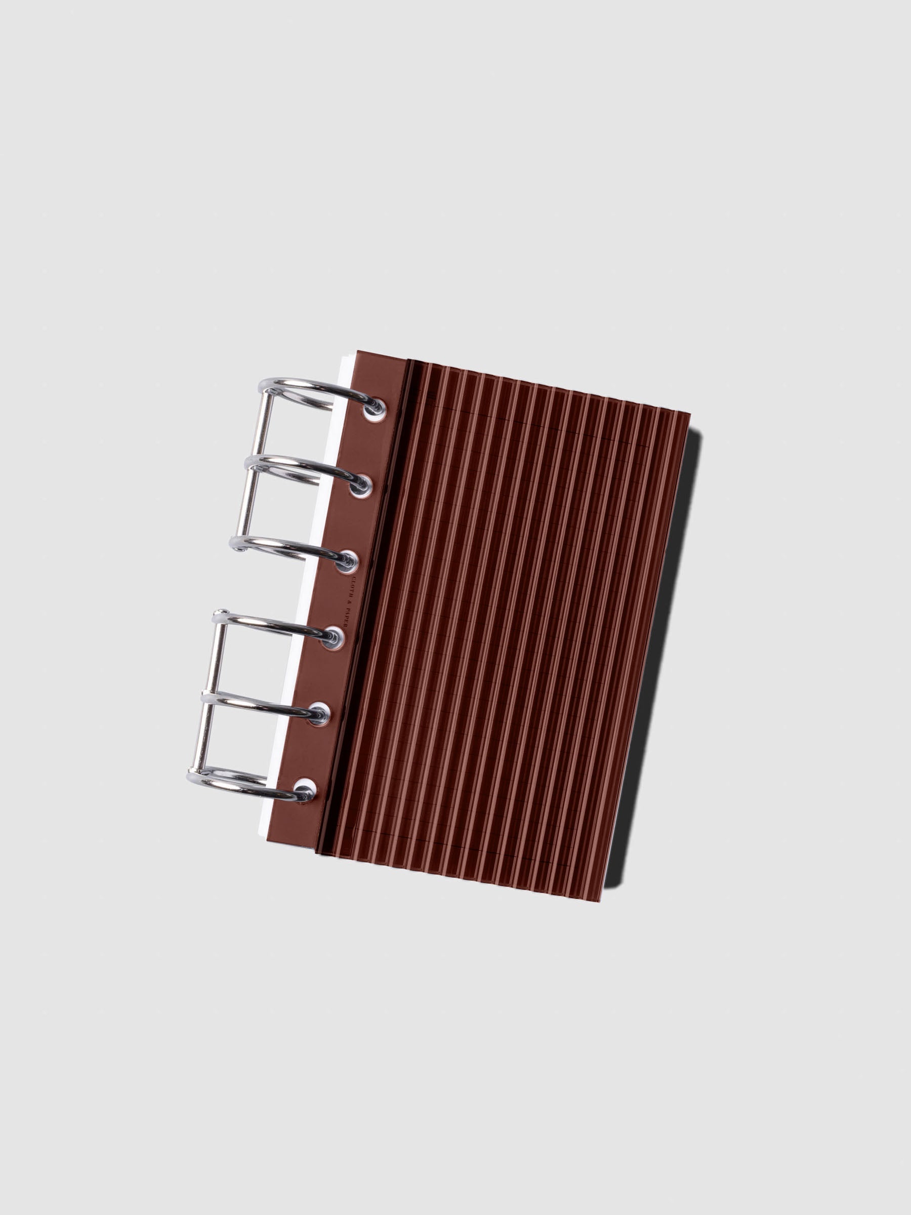 Bordeaux fluted planner dashboard in Pocket size shown on silver six rings at an angle, no cover.