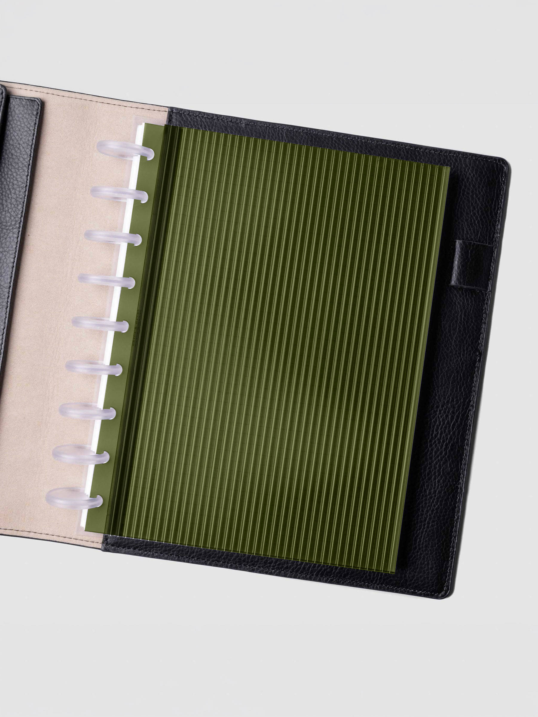 Olive fluted planner dashboard in HP Classic size shown in a black leather discbound cover with clear discs.