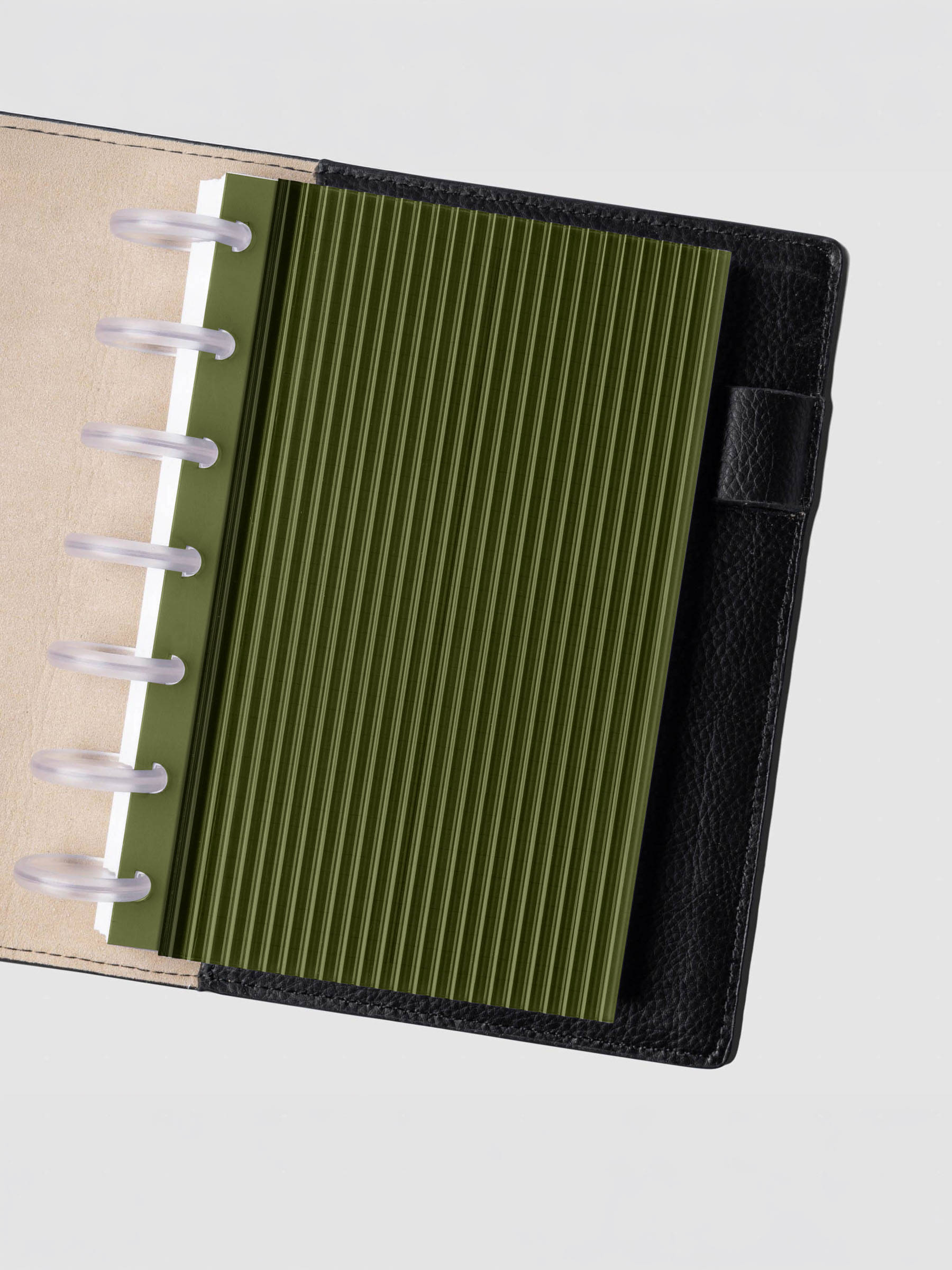 Olive fluted planner dashboard in HP Mini size shown in a black leather discbound cover with clear discs.