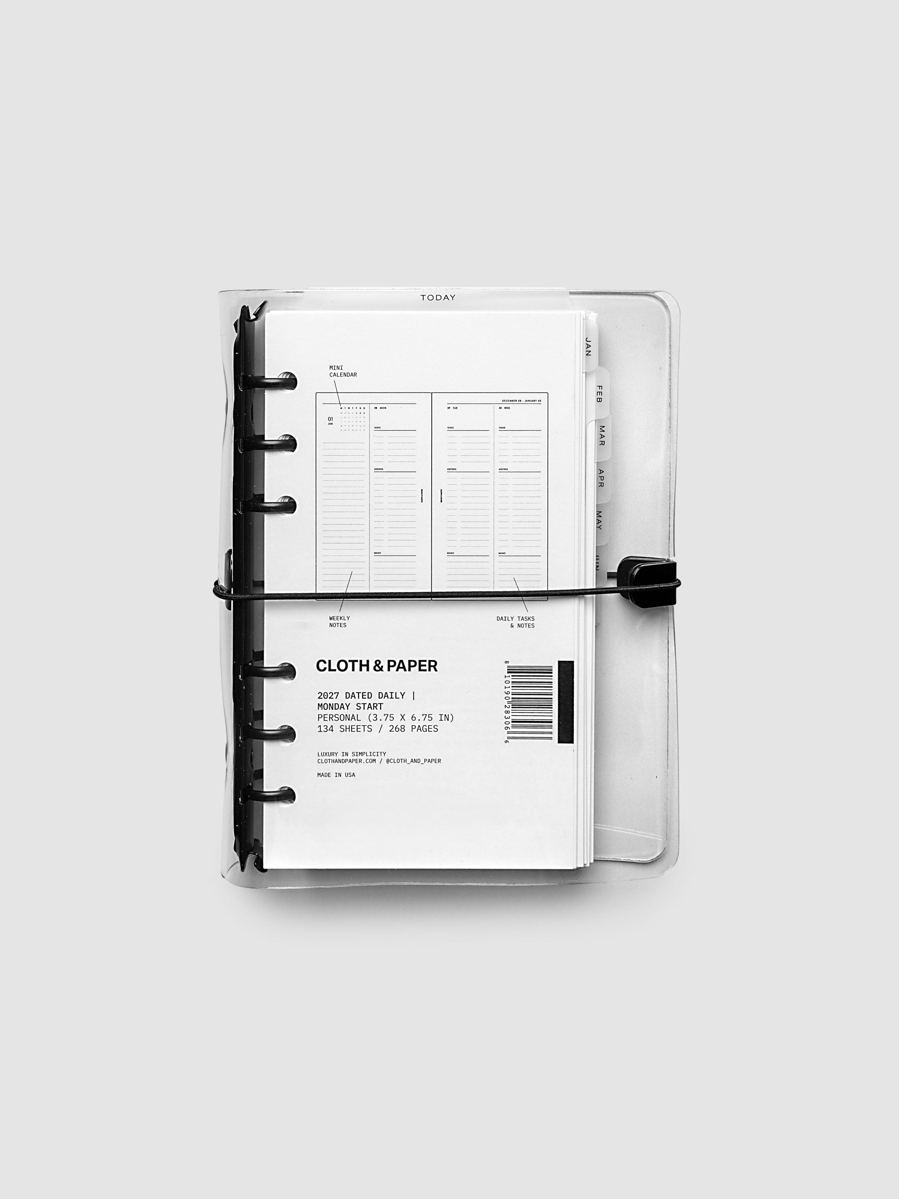 Closed clear vinyl planner cover with black 6-ring binding and a black elastic closure, front page displaying a labeled weekly spread with mini calendar, weekly notes, and daily tasks callouts, Personal 6-Ring Punch size