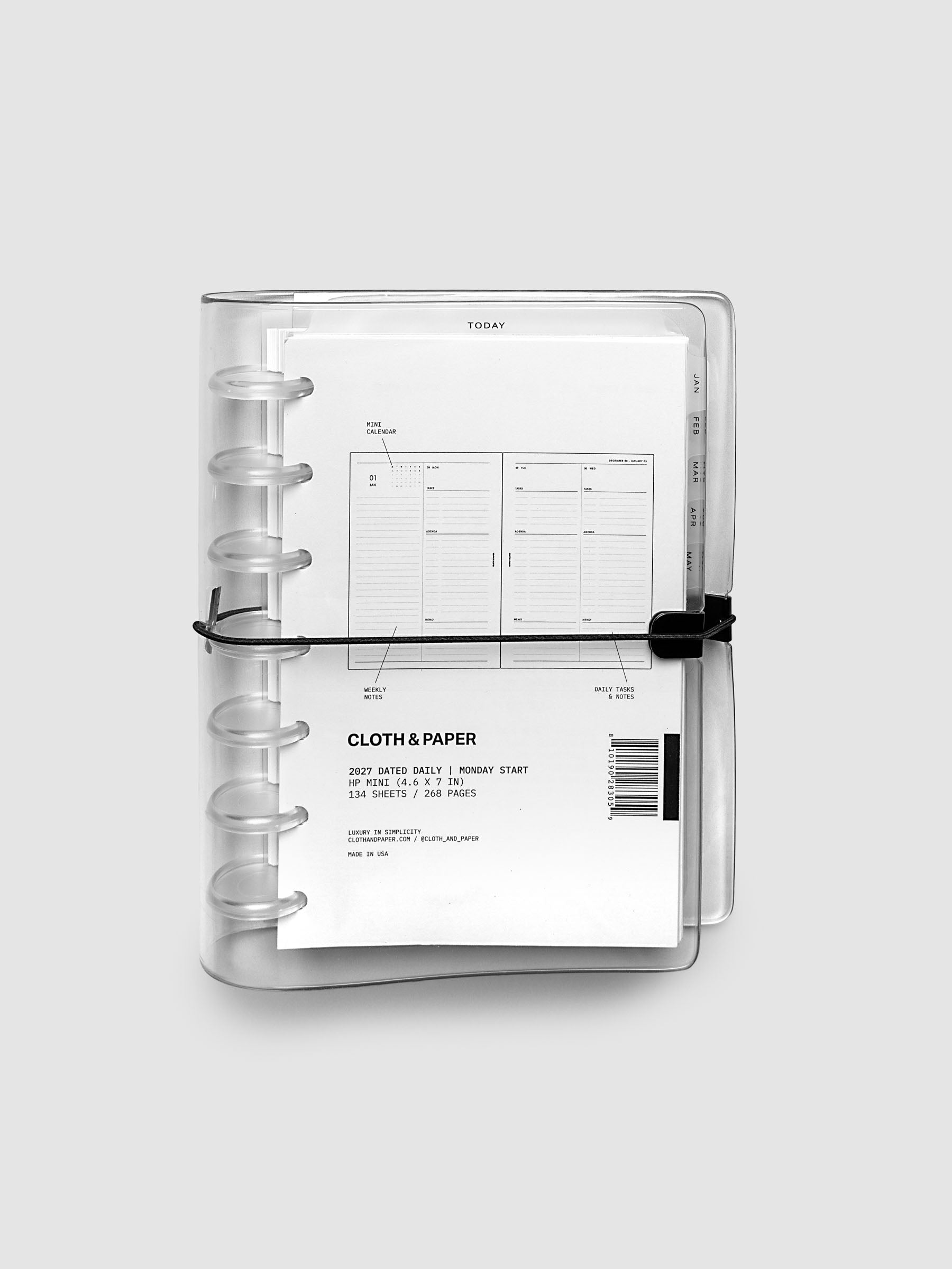 Closed clear vinyl planner cover with clear 7-disc binding and a black elastic closure, front page displaying a labeled weekly spread with mini calendar, weekly notes, and daily tasks callouts, HP Mini 7-Disc Punch size
