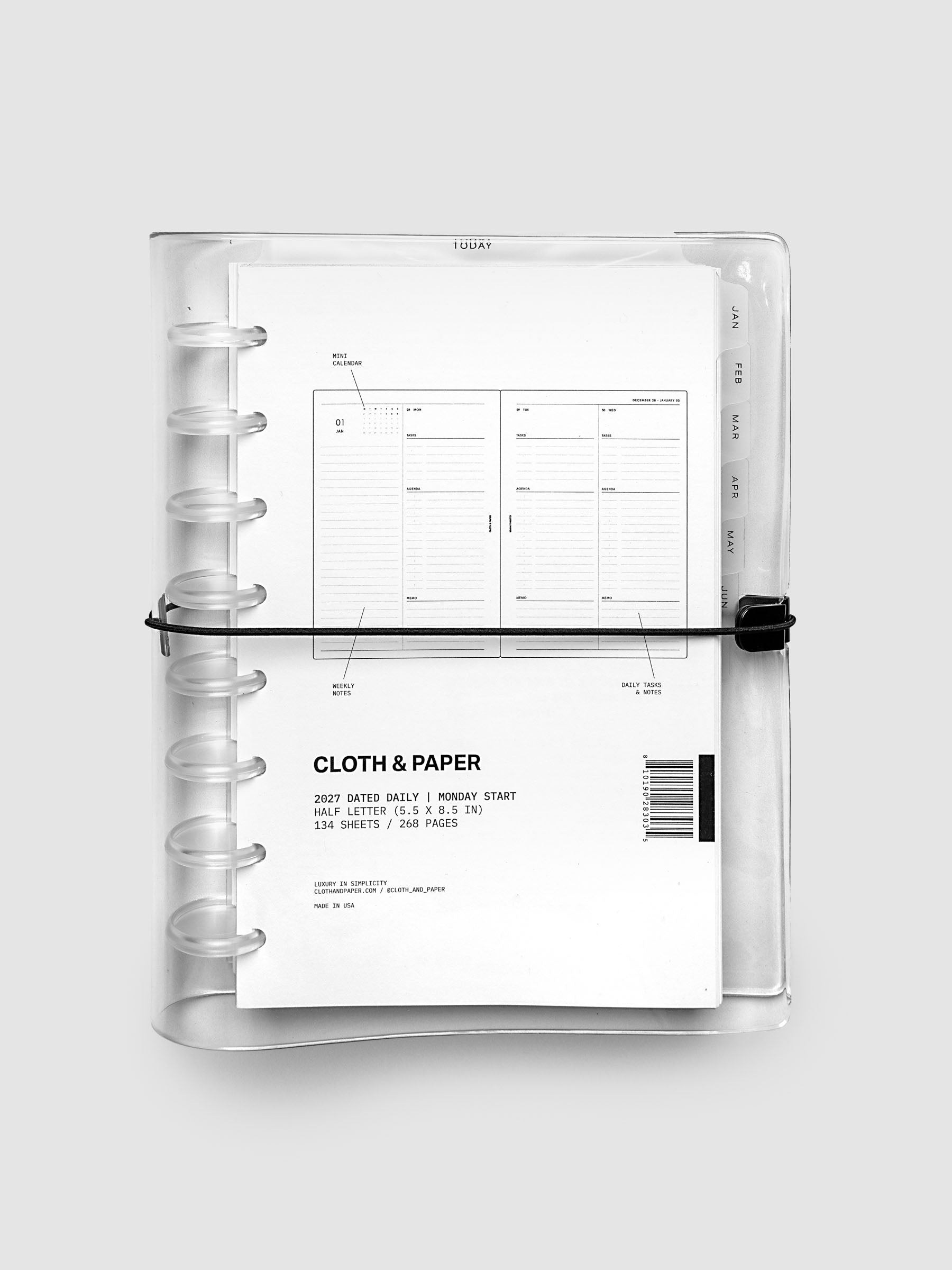 Closed clear vinyl planner cover with clear 8-disc binding and a black elastic closure, front page displaying a labeled weekly spread with mini calendar, weekly notes, and daily tasks callouts, Half Letter 8-Disc Punch size