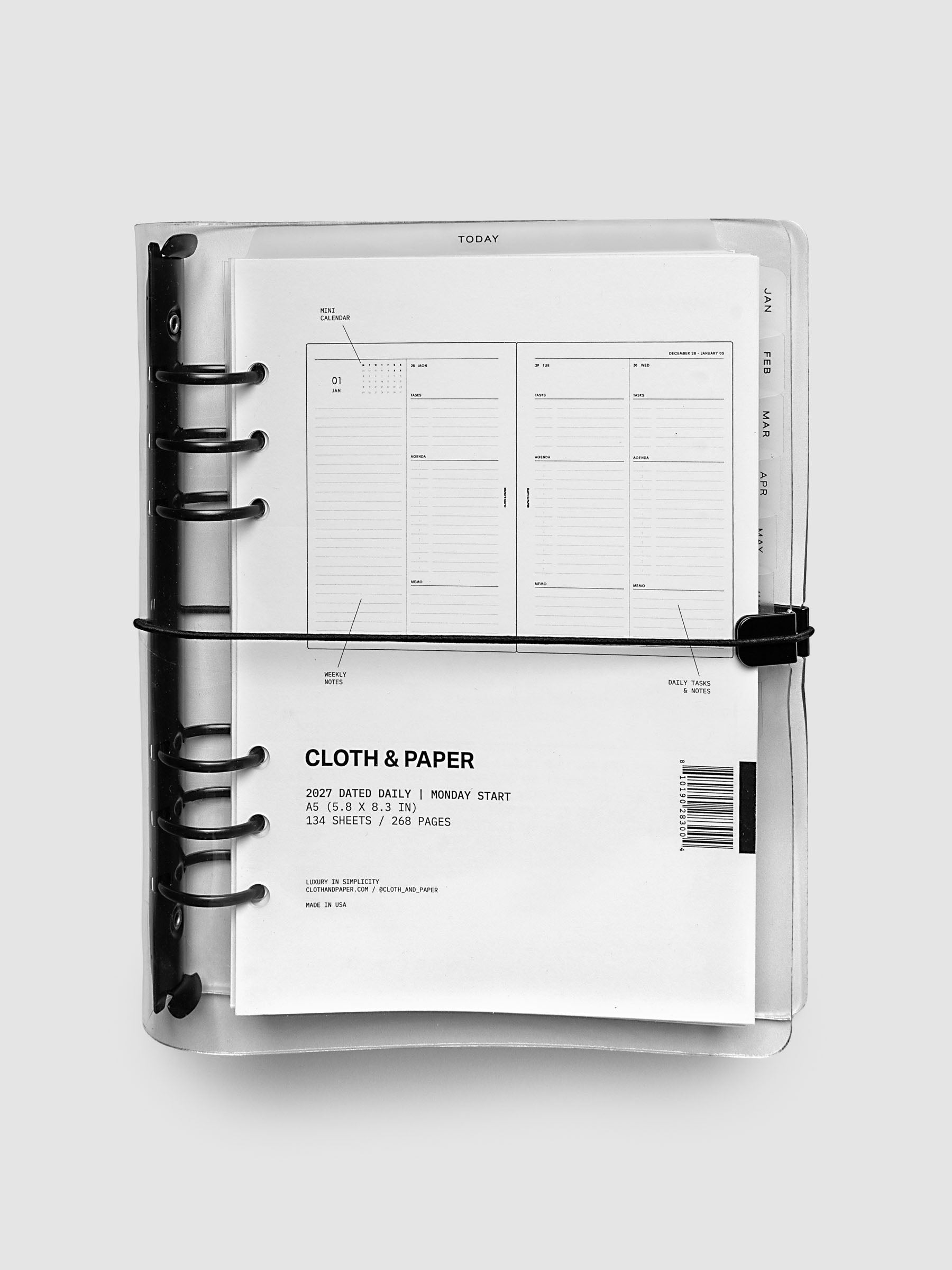 Closed clear vinyl planner cover with black 6-ring binding and a black elastic closure, front page displaying a labeled weekly spread with mini calendar, weekly notes, and daily tasks callouts, A5 6-Ring Punch size