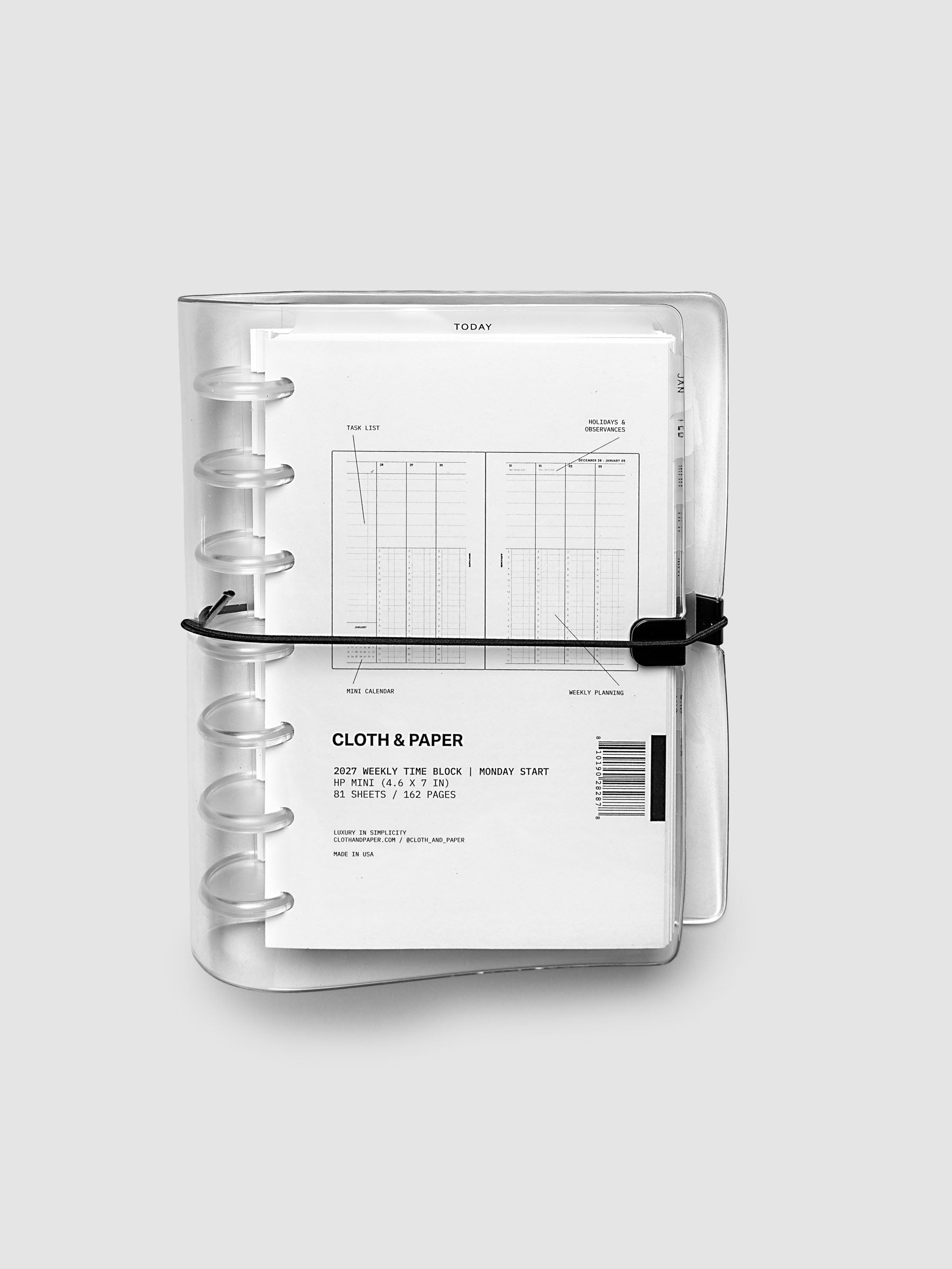 Closed clear vinyl planner cover with clear 7-disc binding and a black elastic closure, front page displaying a labeled weekly time block spread with task list, holidays and observances, mini calendar, and weekly planning callouts, HP Mini 7-Disc Punch size